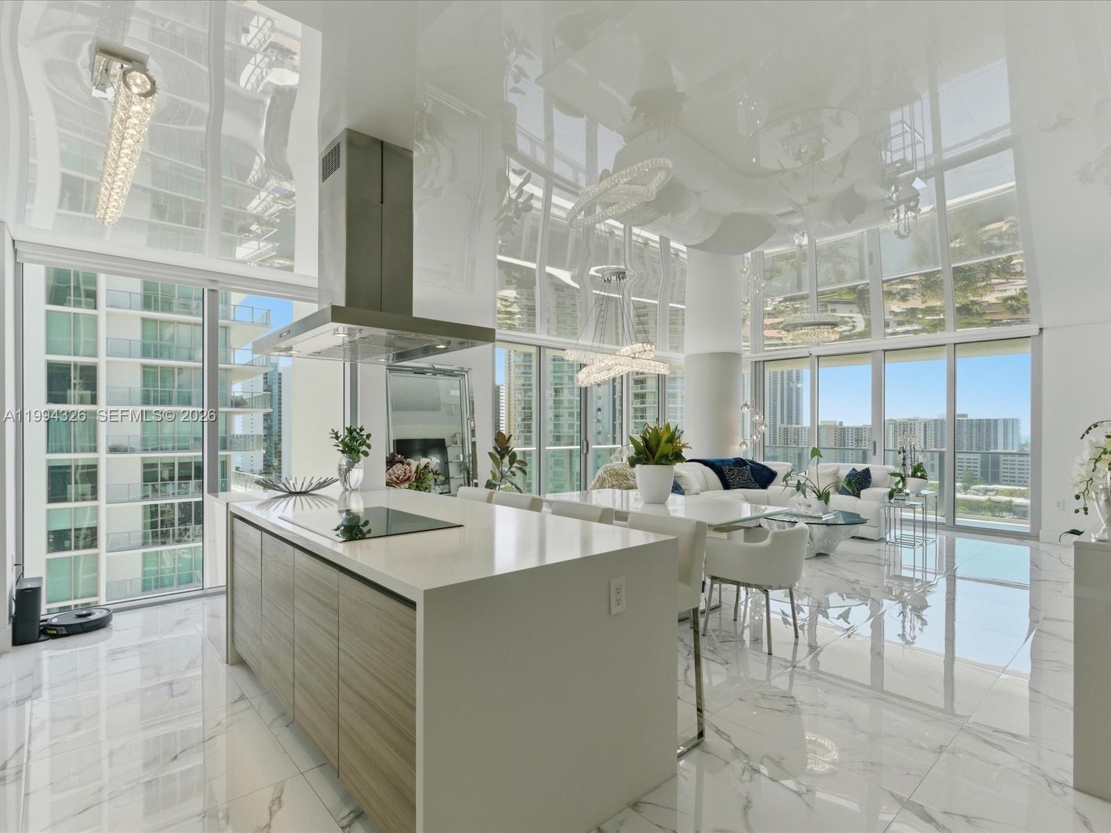 Now is the time to come see this designer decorated, corner line 08 with the most beautiful view from every room and wraparound balcony. Unit has been upgraded with wall paper, electric shades/blackouts throughout, and kitchen counter extension with wine cooler. State of the art ceiling which are giving you a feel for an extra height. Beautiful intracoastal and ocean views. Floor to ceiling impact glass windows, expansive open floor plan. The building offers 5-Star amenities and a special on-demand Suite for guests. Intracoastal magnificent pool with service, Spa, state-of-the-art Gym, Game Room, Reception Room, Bar, Playground, 24/7 Valet Service and Front Desk with multilingual support. Furniture is negotiable. Two assigned, tandem parking spots, plus storage unit. Bring your clients to this dazzling unit! Please see broker remarks.