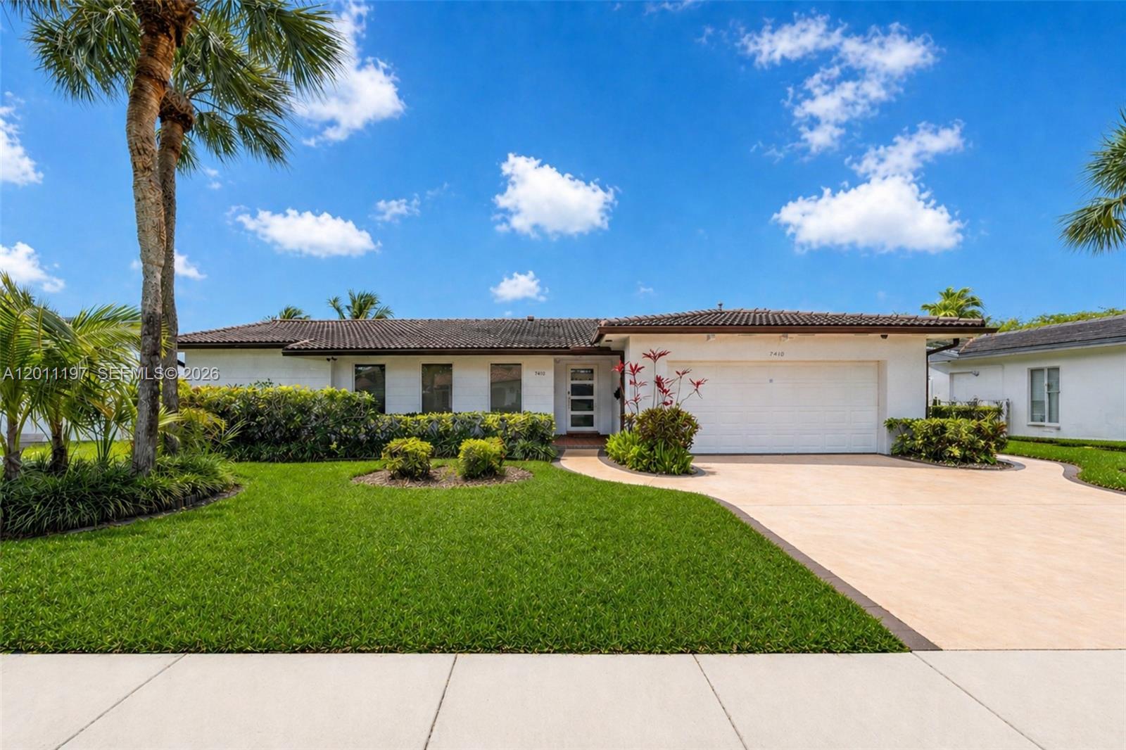 Experience breathtaking sunsets over the lake and sweeping golf course views from a truly exceptional outdoor living space designed to impress. This four-bedroom, three-bathroom residence at 7410 Loch Ness Drive offers a rare blend of serenity and scenery, set within a beautiful, tree-lined neighborhood in the heart of Miami Lakes. The expansive outdoor area features a spacious deck, outdoor kitchen, and dining space, creating the perfect setting for entertaining or simply enjoying the peaceful surroundings. Inside, the home is equally inviting, offering comfort and functionality for everyday living. The neighborhood provides a welcoming atmosphere with nearby lakes, golf course access, shops, and restaurants. Conveniently located near major highways including I-95, I-75, and 826, commuting is effortless. Just 30 minutes from the beaches, Miami International Airport, Fort Lauderdale Airport, Hard Rock Stadium, and the Miami Design District, this property delivers the ideal combination of lifestyle, location, and views.