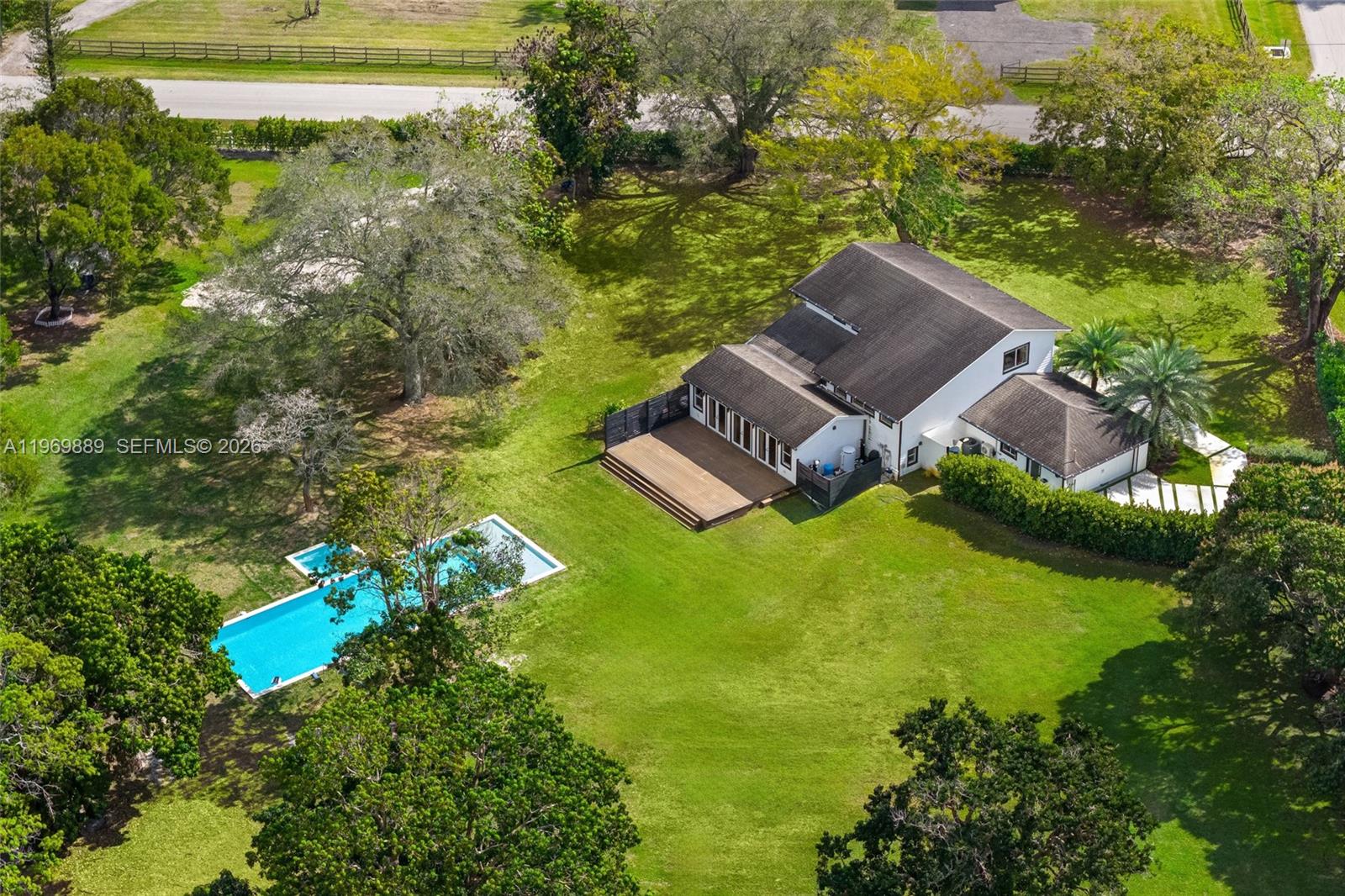 Recently repositioned to reflect current market opportunity. Exceptional value for over 2 acres in highly desirable Southwest Ranches. Move-in ready modern farmhouse with resort-style pool, and privacy.  Seller ready to move and easy to show.  Set on a sprawling corner lot, this beautifully remodeled 4-bedroom, 3-bath residence offers approximately 3,260 sq ft of thoughtfully designed living space, blending timeless farmhouse charm with modern luxury.
Extensively updated, the home features impact windows, high-end kitchen appliances, and bright, inviting interiors filled with natural light. The functional layout offers generous living and dining areas ideal for both everyday comfort and entertaining.
Step outside to your private resort-style oasis, highlighted by a spectacular 60’ x 25’ heated pool and spa, expansive deck, and serene views of mature trees and lush landscaping. Enjoy year-round outdoor living with an automatic irrigation system and a full-perimeter mosquito misting system, creating a comfortable and low-maintenance environment.
Additional highlights include first-floor entry, formal dining space, and ample room for gatherings. Conveniently located near Weston and top-rated Weston schools, this exceptional property offers the perfect balance of privacy, space, and accessibility.
A rare opportunity to own a move-in-ready modern farmhouse in one of South Florida’s most sought-after communities. Schedule your private showing today!