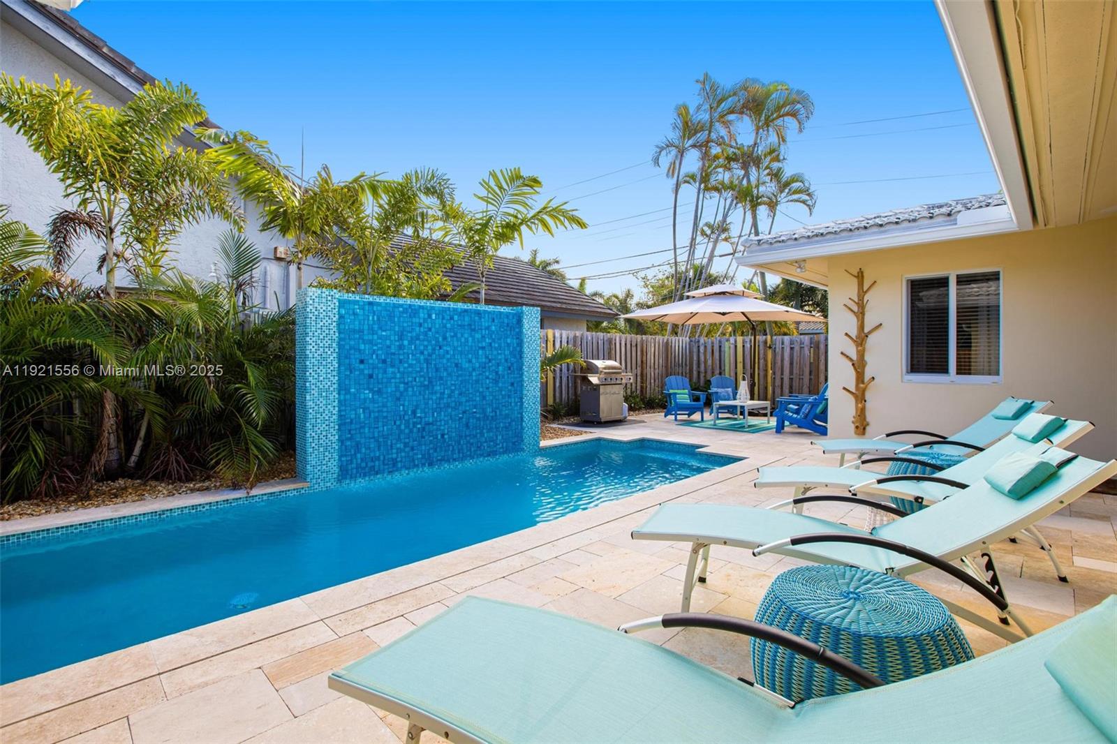 This beautifully updated 3-bedroom, 2-bath home sits on an oversized corner lot and offers the perfect blend of comfort, style, and location. Enjoy peace of mind with a brand-new roof (2024), impact windows and doors, and new sliding doors that open to your private outdoor oasis: a newly built heated pool with waterfall, travertine decking, and lush landscaping—ideal for relaxation or entertaining.

The home features a split floor plan, with a spacious master bedroom that includes a walk-in closet and an ensuite bathroom with a shower. The two additional comfortable bedrooms share a full bathroom with a tub.

You’ll love the bright, illuminated open kitchen, offering full storage, granite countertops, stainless steel appliances, a large island with seating for nine, and a wine cooler with LED lighting. A convenient laundry room adds even more functionality to the home.

The property also provides two covered parking spaces plus a circular driveway for additional parking.

Located across from multimillion-dollar Intracoastal homes and just a short walk to the beach, shopping, dining, and the vibrant nightlife of Lauderdale-by-the-Sea. Don’t miss the opportunity to live where others vacation! It is currently operating as a vacation rental. Equal Housing Opportunity.