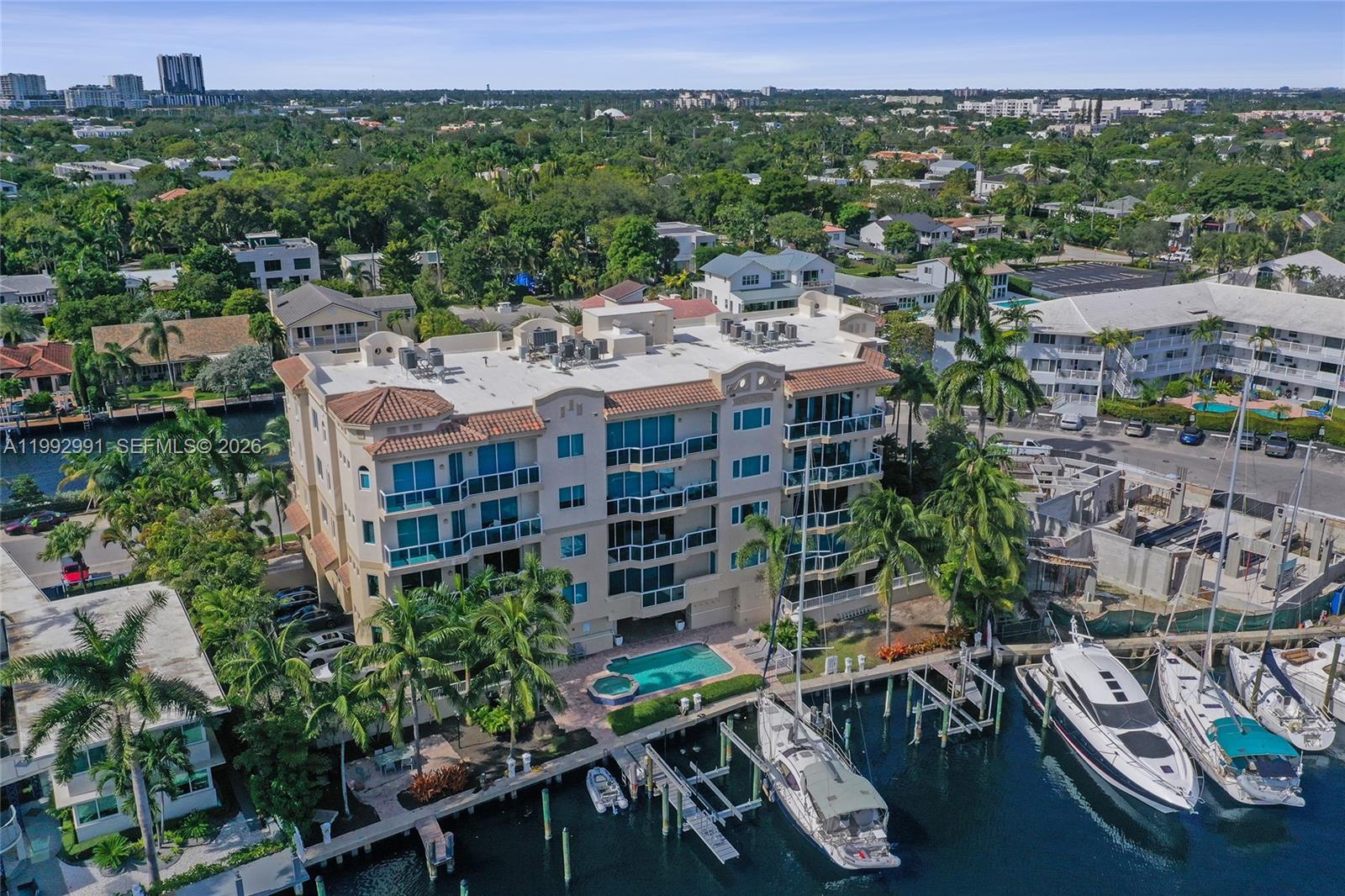 BOATERS, DO NOT MISS OUT. BOAT SLIP and LIFT INCLUDED with this STUNNING corner condo at Hendricks Isle off the vibrant Las Olas. Waterfront elegance in this impressive 2-bedroom, 2 bath residence spanning 2400 square feet. Panoramic water vistas throughout this meticulously maintained condo. Features a grand double-door entrance. Open kitchen boasts all stainless appliances, granite tops and large island w/ built-in wine cooler. Primary and guest bedrooms offer large walk-in closets and spacious en-suites. Additional highlights include formal dining space, laundry room, whole-home water filtration, tankless water heater, two assigned parking spots, plus storage. Building amenities feature a resort-style pool, grilling stations, and modern fitness facility. RESERVES FULLY FUNDED. Seller is motivated and has moved! VIDEO TOUR IN THE LINK.
