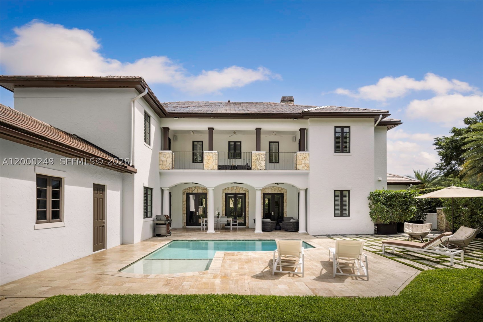 Tucked away on a lush corner lot, Villa Amalfi is an architectural triumph defined by classic Roman columns, coral stone accents, and framed by magnificent Sylvester date palms. Inside, expansive living spaces unfold beneath sweeping curved ceilings, anchored by a magnificent coral stone fireplace, polished marble, and rich Brazilian teak flooring.

The state-of-the-art kitchen—appointed with Sub-Zero, Wolf, and Miele appliances—anchors the home's social spaces, spilling naturally into the light-filled family room and onto expansive travertine terraces. With integrated Sonos sound, custom closet build-outs, elevated lighting, and pristine newly updated baths, Villa Amalfi offers a peaceful, private sanctuary just steps from Merrick Park.