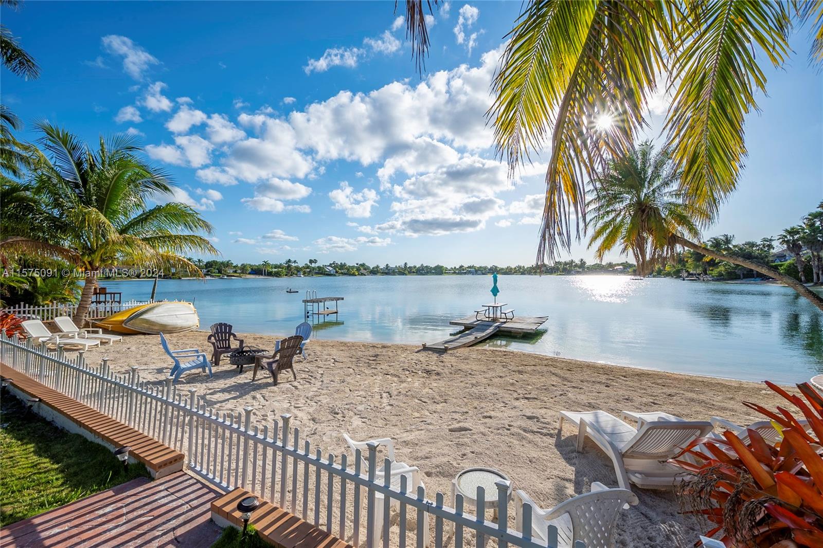 Rare opportunity! Lakefront home with private beach on spring-fed Whispering Pines Lake, with stunning sunset views! The property has a spacious 4 bedroom/3 bathroom main house with an open floor plan, 2nd primary bedroom, and additional 5th bonus room that can be used as a gym, office, studio, efficiency, in-law-quarters, etc. Numerous energy efficient features include solar panels, gas water heater, & gas dryer. The primary bedroom has a huge walk-in closet and dual-person master shower. The kitchen boasts custom wood cabinets, Thermador appliances, gas range, convection oven, a 9-foot island, and quartz countertops. Not in a flood zone. Seller credit for cast iron plumbing. A metal roof, Bahamian shutters, and partial impact doors/windows/shutters offer additional protection. Must see!