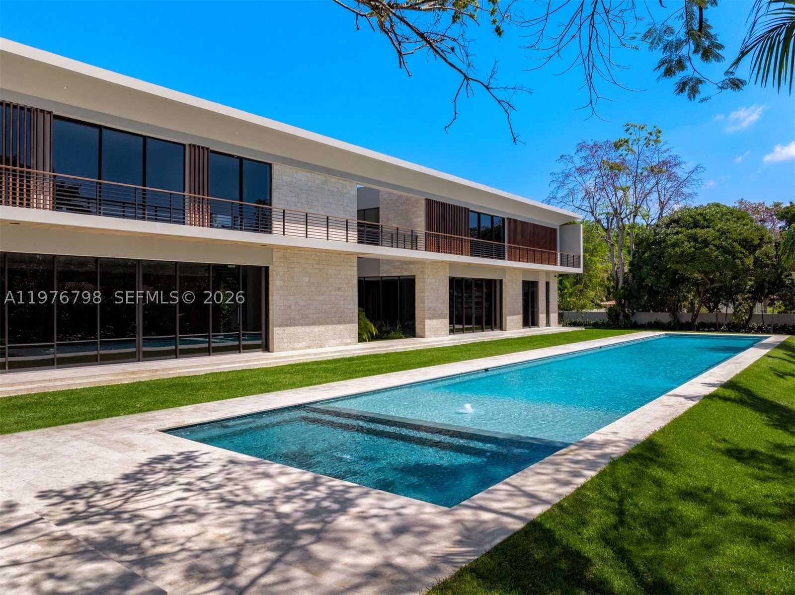 Step into Villa Straordinaria, a modern masterpiece set on a lush 1 Acre lot in coveted Ponce Davis. Built by CALTA Group, this 13,008 total sq ft estate offers 6 bedrooms, 6.5 baths, and world-class amenities throughout. Designed with refined sophistication, interiors feature Mia Cucina millwork, wood and porcelain floors, recessed Alcon lighting, and state-of-the-art Lutron AV systems. Enjoy indoor luxuries including a theater, media room, spa, gym, and staff quarters. Outdoors, a tropical poolscape, expansive 150' x 25' pool, 3-car garage with ample driveway space for additional vehicles, and summer kitchen with Wolf and Subzero appliances complete this private resort-like retreat. Villa Straordinaria is the epitome of modern elegance and grand-scale living.