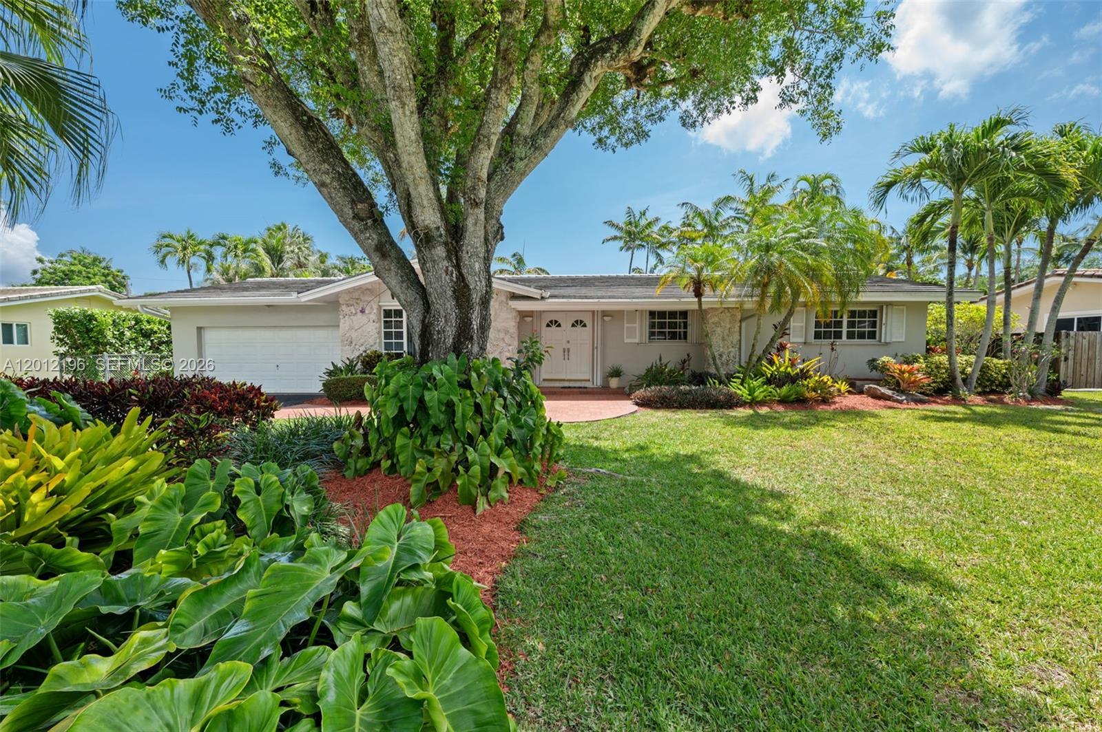 In the heart of Palmetto Bay, just 4 minutes from the bayfront Deering Estate Nature Reserve, this beautifully maintained home is a move-in ready South Florida classic. The layout delivers distinct rooms for relaxing, dining & entertaining, while the wide-open passages & vaulted ceilings afford a wonderful sense of flow & connectivity + a generous sense of space. Light pours into every room thru broad window banks & glass doors, augmented by designer lighting & lighted ceilings fans. Creamy tile floors, along with a crisp white kitchen, boost the light, bright ambiance. You might, however, find yourself spending much more time outside enjoying the large screened patio & swimming pool, as well as the big backyard secluded by a dense privacy hedge. Cabana bath, large laundry, 2-car garage.