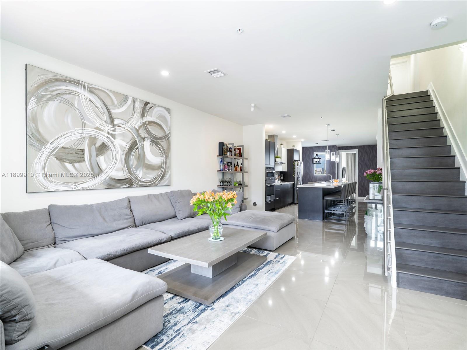 Exceptional opportunity to own in Landmark, one of Doral’s most sought-after communities. This modern three-story condo offers 1,923 Sq.Ft. of stylish living with 3 bedrooms + Converted DEN, 2.5 baths, and a private one-car garage. Enjoy open, light-filled interiors, elegant porcelain flooring, and a chef’s kitchen with premium appliances, a large quartz island with seating for six, and a built-in wine cooler. The primary suite features a spacious walk-in closet and spa-style bath with dual floating vanities and a glass-enclosed shower. Residents have access to Landmark’s luxurious clubhouse with a resort-style pool, fitness center, and social areas designed for modern living.