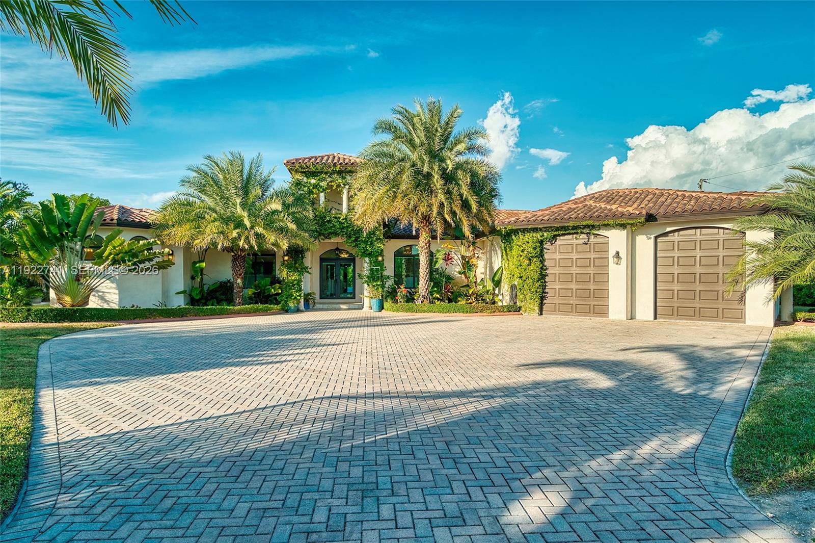 Discover luxury, privacy, and lifestyle at this exceptional residence on a lush corner acre in Redland–Homestead, designed for comfort and outdoor living. This custom single-level home offers 4 spacious bedrooms and 3.5 bathrooms, including a large primary suite with dual walk-in closets and a spa-inspired bath with his-and-hers vanities and a walk-through shower. A thoughtful split-bedroom layout, soaring ceilings, and 24x48 porcelain tile flooring elevate the interior.

The open-concept family room features a modern electric fireplace and flows directly to the covered terrace. The chef’s kitchen includes a large island, extended counter seating, and seamless connection to the main living areas.

Outdoors, enjoy a full summer kitchen, built-in bar, mounted TV, and pergola lounge. The heated resort-style pool offers a swim-up bar and cascading water feature. The acre is fully landscaped and irrigated by three wells, showcasing 40+ mature fruit trees including mango, avocado, mamey, and citrus. Additional features include a finished garage with car lift, full irrigation system, gated and fenced perimeter, and high-end finishes throughout.

Located in Homestead’s desirable Redland agricultural zone, the property offers space and privacy while remaining close to shopping, dining, Fruit & Spice Park, Schnebly’s Winery, and major roadways. Zoned EU-1, allowing ownership of horses, chickens, beekeeping, and more.