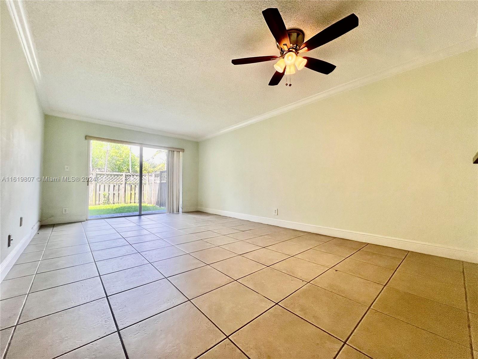 Highly desired unit featuring a PRIVATE BACKYARD. This spacious 1 bedroom, 1 bathroom condo offers an oversized yard for outdoor enjoyment. With a tile floor, a large kitchen, abundant closet space and lots of light, this is the perfect spot for you.  The community is exceptional, offering 3 pools, tennis courts, clubhouse, and gym. Conveniently situated in Doral, close to the new Doral Downtown Development, top-rated schools within walking distance, and easy access to the Palmetto Expressway, hospitals, banks, and shopping facilities.