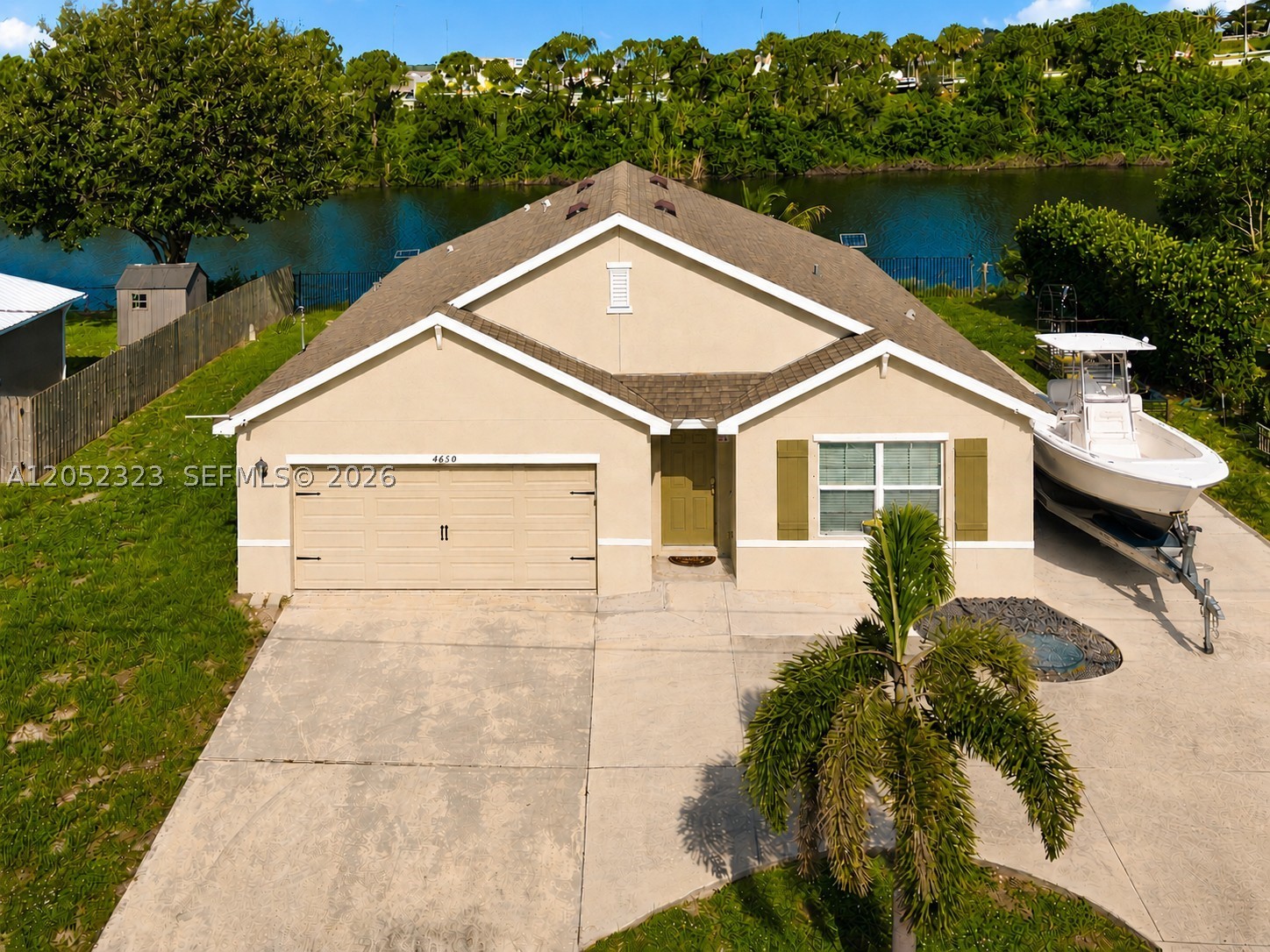 Welcome to this beautifully maintained 2021-built waterfront home offering the perfect combination of modern design, functionality, & freedom with NO HOA! This 4-bedroom, 2-bathroom home features a bright, open-concept floor plan that's ideal for both everyday living & entertaining. The spacious living area flows seamlessly with the open kitchen. Large windows bring in abundant natural light while showcasing water views from both the Living Room & Primary Suite. Outside, enjoy the rare convenience of a long side driveway with ample room to park an RV, boat, trailer, or other recreational vehicles—a highly sought-after feature here in Port Saint Lucie. HOME HIGHLIGHTS: 2021 ROOF, 2021 A/C & WATER HEATER, NEW WASHER & DRYER, NEWLY PAINTED INTERIOR THROUGHOUT, NEW 2026 LUXURY VINYL FLOORING IN ALL 4 BEDROOMS, RECESSED LIGHTING THROUGHOUT, COMPLETE STORM PROTECTION, & ON CITY SEWER. Located on a dead-end street in a desirable Port Saint Lucie neighborhood with easy interstate highway access, this move-in-ready home offers new modern concrete block construction, low-maintenance living, & the flexibility that comes with no HOA restrictions. ENDLESS POSSIBILITIES!