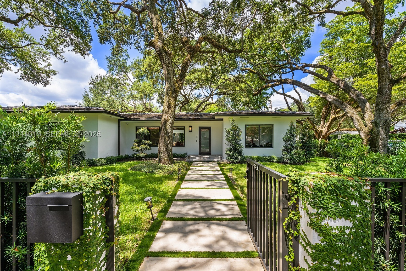 Fully renovated 3 bedroom, 4 bath contemporary corner residence in the heart of Coral Gables Golden Triangle area. This home features an open floor plan with wood floors throughout, a fenced yard with heated pool and spa, surrounded by beautifully landscaped, meticulously trimmed oak trees with lighting. Additional highlights include a two-car air conditioned garage, freshly painted interior and exterior, a new laundry/storage room, Lutron lighting system, NVR hardwired security cameras with app access, and TVs included. Space to expand square footage.