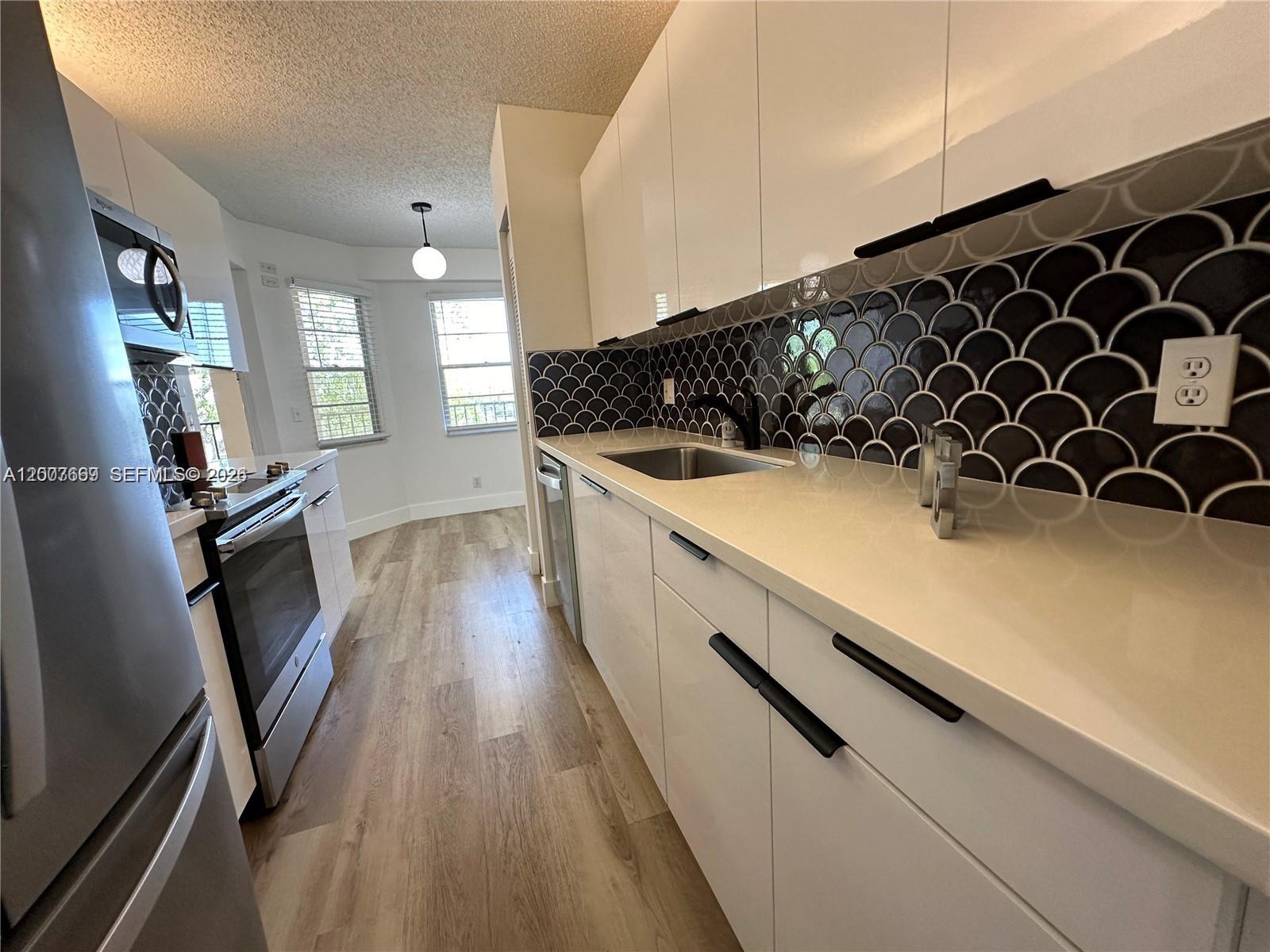 "AS IS"  Adorable 2/2 remodeled condo with private garden view.  New laminated floors, kitchen, and bathrooms with granite counter tops, appliances,  washer and dryer inside unit.  Great location, close to I-75, Sawgrass expressway, Hospitals, restaurants, shopping centers and much more.  Great community for 55+ adults with many ammenities.   This unit also allows rentals.
