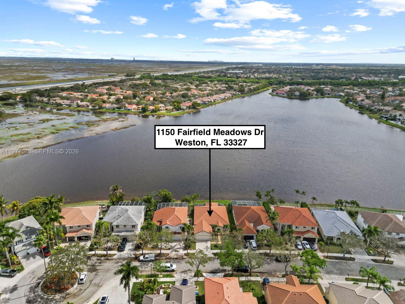 Here is your opportunity to live on the most coveted water views Weston has to offer. Located in the highly sought after gated community, The Meadows. From the moment you step foot into this beautiful 4 bed, 2.5 bath home, you will be mesmerized by the breathtaking lake view. Fall in love with the vast living space, volume ceilings, and beautiful flooring (2020). Complete impact windows and doors (2024) provide plenty of natural light to brighten the home. Entertain with ease in a modernized kitchen with new 2025 appliances while overlooking the lake from the family room or breakfast nook! The oversized primary bedroom boasts a large custom walk-in closet and a luxurious spa-like bathroom. All bedrooms feature custom closets and all bathrooms renovated (2025). From experiencing the sunrise with your morning cup of coffee to hosting guests for lunch or dinner on the patio (re-screened March 2026), relish in the fresh breeze and serene water view. Enjoy the convenience of a dedicated laundry room. 2-car garage with ample storage space. Various community amenities including a pool, basketball and pickleball courts, and a playground. Please note these photos are not AI-generated, this home is actually just as beautiful, if not more, in person!