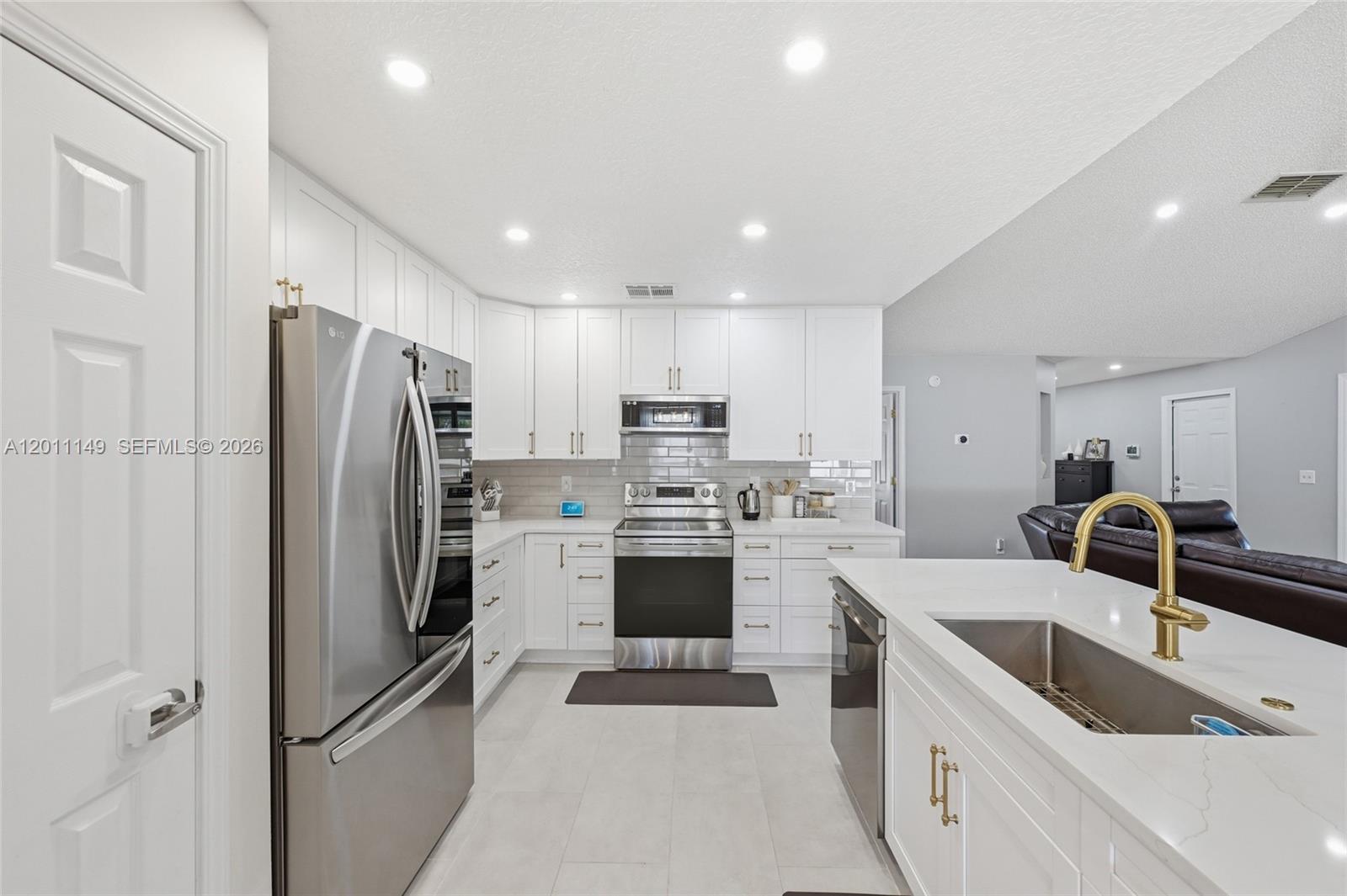 Beautifully reimagined with extensive upgrades completed within the last two years, this move-in-ready home delivers the perfect blend of modern style, comfort, and functionality. From the moment you step inside, you'll notice the attention to detail and elevated finishes throughout. The open-concept layout is anchored by a show-stopping kitchen designed for both daily living and entertaining, featuring quartz countertops, soft-close cabinetry, a designer brick ceramic backsplash, upgraded lighting, tile flooring, and an oversized island with integrated sink--creating a seamless space to gather and connect. The spacious primary suite offers a true retreat with vaulted ceilings and premium thick-mil plank hardwood flooring, while the fully updated en-suite bath showcases a freestanding soaking tub, anti-fog LED mirror, and sleek soft-close cabinetry, delivering a spa-like experience at home. Major system and smart upgrades add long-term value and peace of mind, including a new water heater,whole-home water filtration system (2022), smart thermostat, the roof was replaced in 2020.