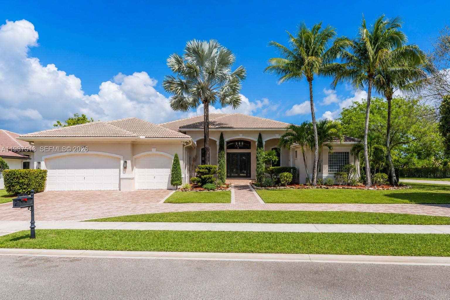 Stunning lakefront home located in the exclusive guard-gated community of Riverstone in West Davie. This spacious residence features six bedrooms and five full bathrooms, including three en-suite bedrooms.
Grand living space with volume ceilings and a formal dining room, creating an open and impressive layout. Designed for entertaining, the home features a step-down wet bar with beverage cooler, over 4,200 square feet of custom granite flooring, and 8-foot high interior and exterior doors throughout.The primary suite includes dual vanities, a soaking tub, and an oversized custom marble walk-through shower. The home is equipped with a tankless water heater, three newer AC units (2020+), and hurricane-impact doors, providing full hurricane protection. Designed for entertaining both inside and out, the outdoor space features a summer kitchen, tropical landscaping, and a resort-style pool area. The patio is fully enclosed with hurricane shutters, and a cabana bath provides direct access to the pool. The pool was remodeled in 2020 and includes a saltwater system, new heater and pumps, and full automation controlled via app. Tall privacy hedges surround the large one-plus-acre corner lot.
Community amenities include a guard-gated entry, pickleball courts, basketball courts, pavilion, and playground. Riverstone is conveniently located near Vista View Park, highways, shopping, dining, airport, and hospital.
Move-in ready and meticulously maintained.