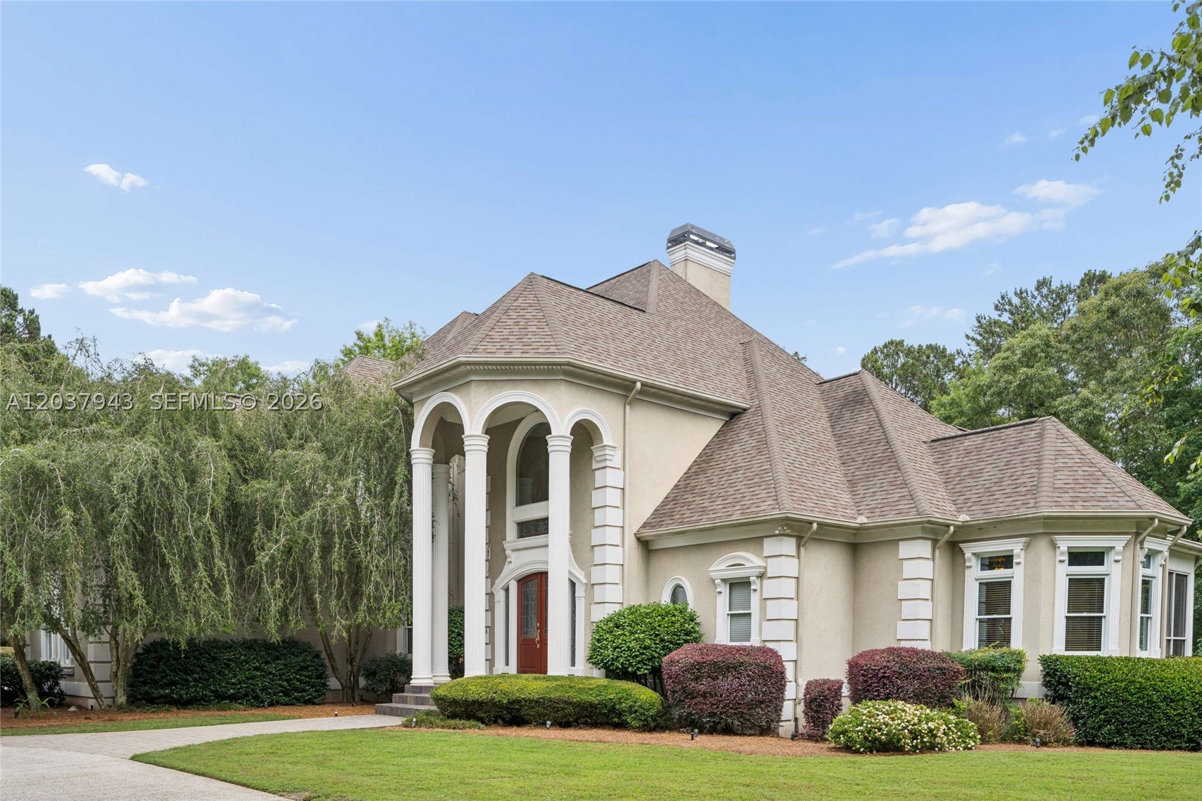 Set on the fifth hole of the golf course, this Chateau Elan estate offers rare privacy, space, and resort-style living on a 1.6-acre tree-lined lot. Located inside the gated Legends section, the home welcomes you with a half-circle driveway, a 3-car attached garage, and an additional detached 3-car garage. Inside, the two-story foyer opens to a dramatic family room and formal dining room, creating a layout made for everyday comfort and memorable gatherings. The open kitchen overlooks the keeping room, giving you a warm, connected space for cooking, hosting, and relaxing. The primary suite is located on the main level and features a spacious bedroom with a private patio overlooking the manicured yard. Large secondary bedrooms provide room for guests, workspaces, or flexible living needs. Enjoy outdoor living from the expansive patio with views of the golf course, or take advantage of the private wooded surroundings for a peaceful retreat at home. The full finished basement adds even more lifestyle space with a media room, game and entertainment area, bonus room, and sauna-style shower. Enjoy fall nights or summer cookouts under the custom gazebo and cabana areas. These represent just a fraction of the potential this large private lot has to offer. Just minutes from Chateau Elan Winery & Resort, offering access to dining, spa services, golf, and resort amenities. Schedule your private showing and experience the privacy, space, and golf course setting this home has to offer.