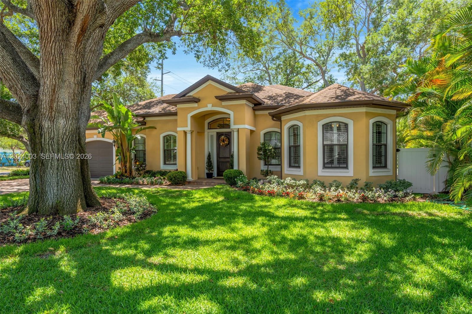 Step into an elegant 3BR/2.5BA private pool estate blending tropical beauty with Mediterranean style in premium South Tampa. This rare custom-built single-story home, built in 2013, offers pure luxury on an oversized 0.29-acre double lot featuring 3,060 Sq. Ft. in total with no HOA and NO flood insurance required.
From the moment you arrive, a generous 50ft stone driveway welcomes you to an oversized property capable of parking boats, RV’s, or up to 6 cars. The open-concept layout features 10-ft ceilings, beautiful archways, and a chef’s kitchen with custom hardwood cabinetry, imported Italian gas range, and French doors opening to a private backyard oasis with a saltwater pool with a light package, garden w/edible plants, and screened lanai perfect for year-round entertaining. The expansive primary suite provides a peaceful retreat, while two additional bedrooms offer flexibility for guests or home offices. Additional highlights include an oversized garage, 2 detached structures (currently a private gym, and storage). Enhanced storm-protection features: hurricane windows, two generator backup systems, underground utilities, new 2026 A/C, and a rare 120-ft private freshwater well (water your lawn for free). Located just 2 minutes from Bayshore Boulevard, 7 minutes from Downtown Tampa & Hyde Park Village; 20 mins to St. Petersburg and ocean beaches. Enjoy a purpose-built estate just minutes from Tampa’s vibrant culture and attractions. One or more photos are virtually staged.