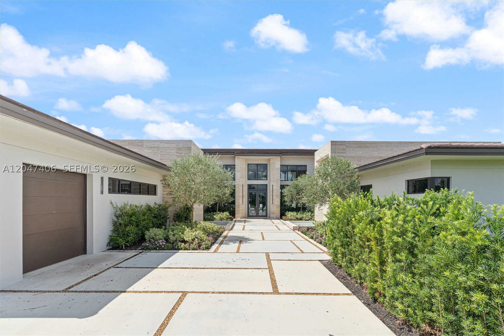 A masterpiece of Mediterranean charm and modern luxury, this 5BD/5.5BA custom estate features a den, media room, mud room, and a 3-car garage with a sleek glass wall. Bold travertine walls and cascading water features create a spa-like entry that sets the tone for the elegant design throughout. Enjoy two outdoor pergolas—one with a summer kitchen for entertaining, the other off the primary suite for private lounging. The resort-style pool, fully landscaped grounds, and high-end finishes complete this one-of-a-kind home. Located in a private 12-residence enclave, this is one of the final homes. Every detail has been meticulously curated for elevated living.
