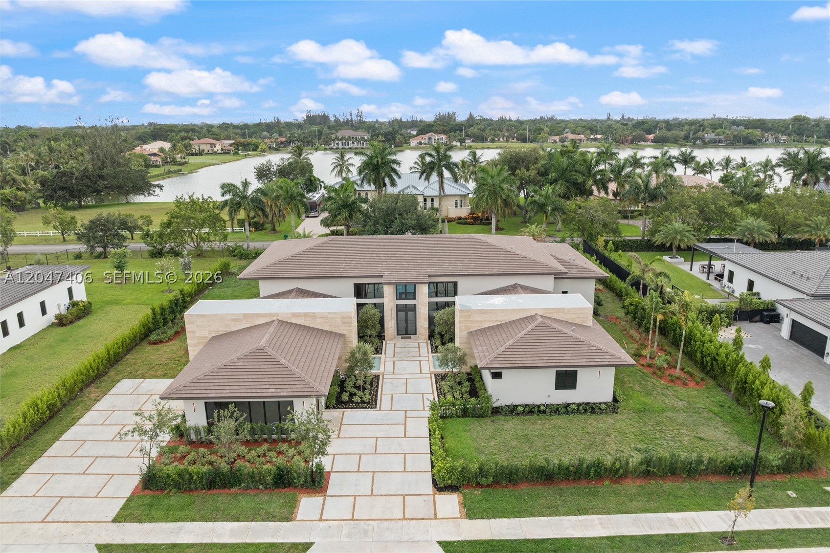 A masterpiece of Mediterranean charm and modern luxury, this 5BD/5.5BA custom estate features a den, media room, mud room, and a 3-car garage with a sleek glass wall. Bold travertine walls and cascading water features create a spa-like entry that sets the tone for the elegant design throughout. Enjoy two outdoor pergolas—one with a summer kitchen for entertaining, the other off the primary suite for private lounging. The resort-style pool, fully landscaped grounds, and high-end finishes complete this one-of-a-kind home. Located in a private 12-residence enclave, this is one of the final homes. Every detail has been meticulously curated for elevated living.