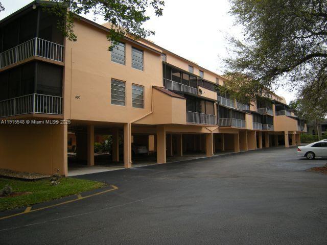 400 Commodore Dr, Apt 108 is a charming 2-bedroom, 2-bathroom condo nestled in the gated Lago West community in Plantation. Inside, you’ll find a mix of Berber Carpet and Tile flooring, a functional layout with split bedrooms, and a practical in-unit washer/dryer.  Brand new Hurricane resistant door and Windows. The screened patio offers a peaceful retreat with garden views. The screened patio offers a peaceful retreat. Within a community rich in amenities — including a clubhouse, fitness center, pool, and tennis courts — all secured behind a gated entrance.  Its central location provides very easy access to major highways, shopping options like Sawgrass Mall, and top-rated schools, making it both comfortable and convenient. Pet-friendly community.