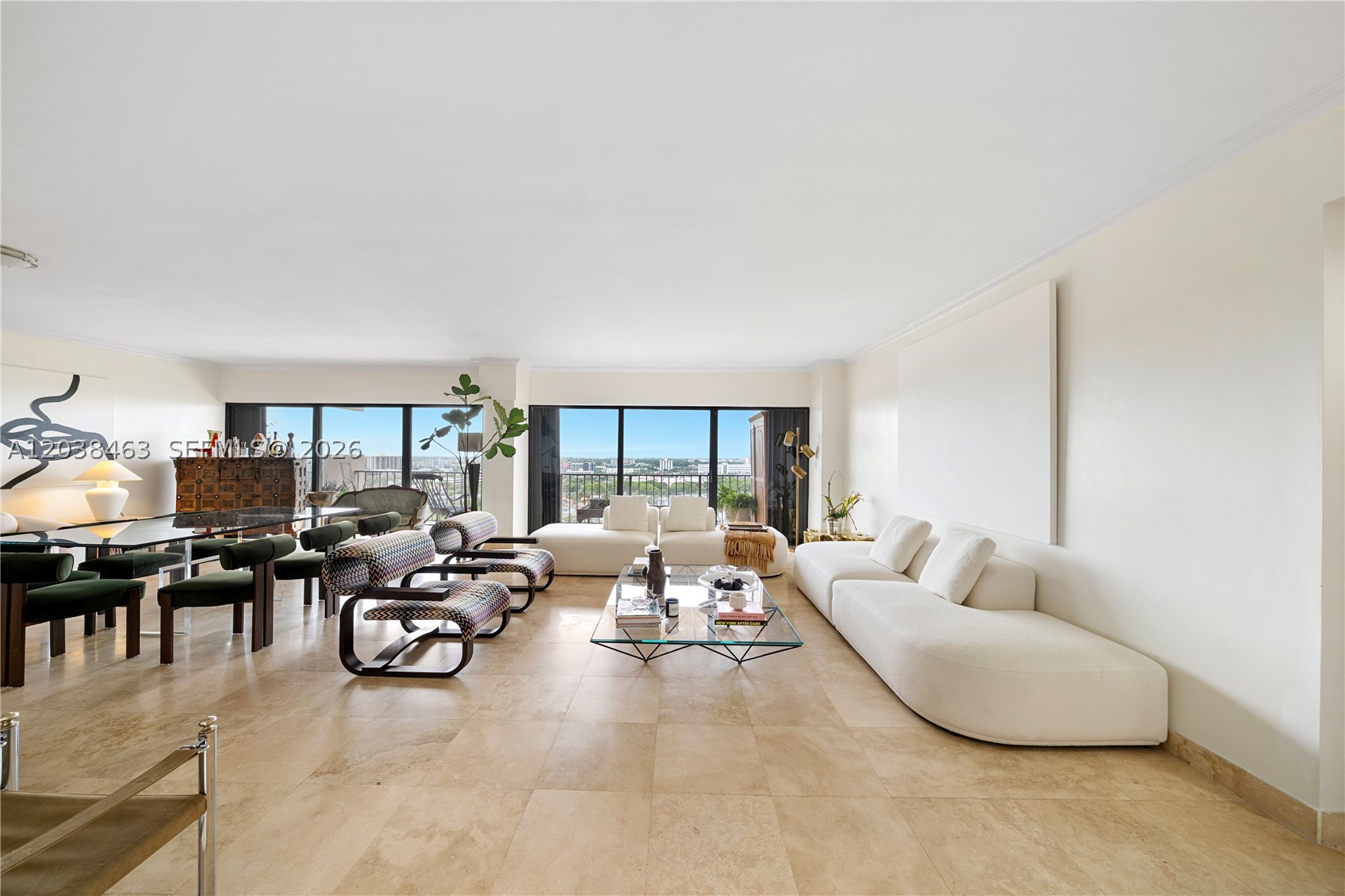 CRICKET CLUB RESIDENCE WITH PANORAMIC VIEWS OF THE WATER, LUSH TROPICAL LANDSCAPES, AND THE SPARKLING MIAMI SKYLINE! This oversized home spans 1,950 interior SF featuring 2 bedrooms + 3 bathrooms & an extra-large balcony showcasing expansive water and city views. The beautifully updated kitchen features custom sage-green cabinetry, granite countertops + abundant storage & stainless-steel appliances. The expansive primary suite offers separate custom-designed dressing closets. Additional highlights include an in-unit washer and dryer & generous storage throughout. X assigned parking spaces. Residents of the Cricket Club will benefit from a comprehensive building restoration and modernization program currently underway, enhancing the community's long-term value and appeal. Please note that select amenities may be temporarily limited during the improvement process.
