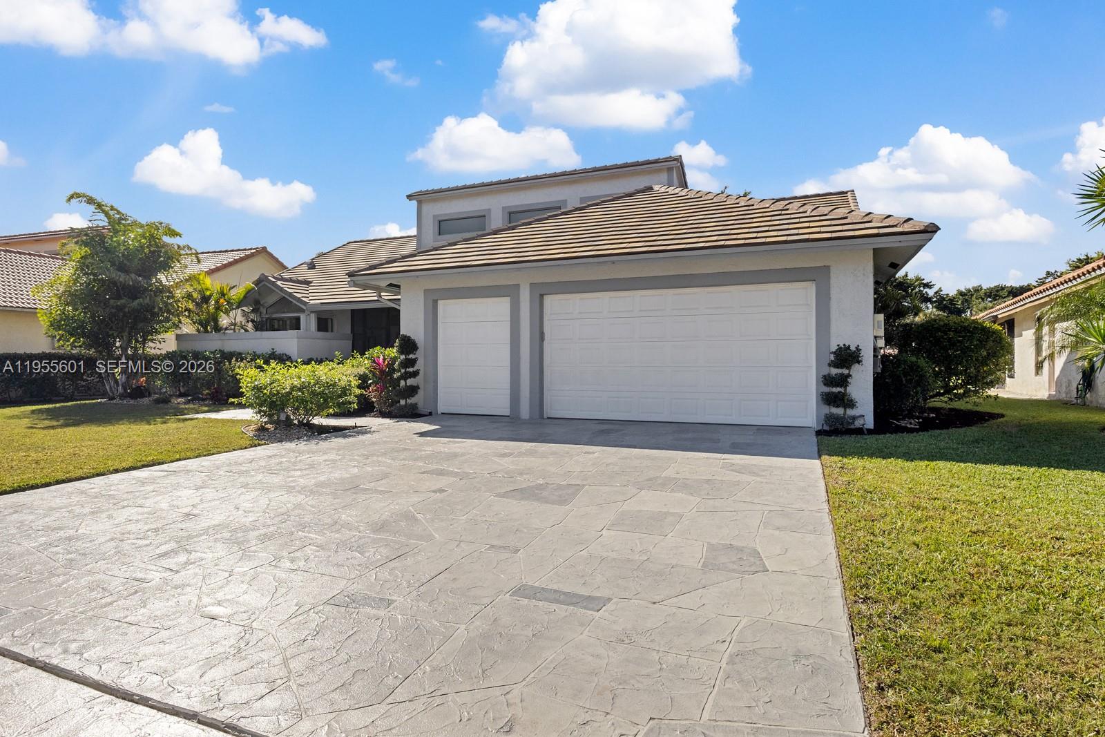 A completely renovated beautiful golf view home in Boca Raton. No mandatory golf and tennis membership required. This home features; a new roof in 2022, solar panels, white shaker 42 inch kitchen cabinetry, quartz countertops, stainless steel appliances, volume ceilings throughout, waterproof vinyl flooring throughout the home, modern bathroom design, open floor plan, new landscaping, private screened in pool, new pool heater, wide canal and golf views, 3 car garage, new driveway pavers, new pool deck, central vac, two A/C units 2022, hurricane shutters, low HOA, includes cable and high speed internet, guard gated security. This home has it all, it checks all the boxes in prestigious Boca Raton. Enjoy the convenience of being just minutes from shops, restaurants, major highways, parks, nearby walking and bike trails, a nature center water park, and houses of worship. Zoned for top-rated schools, this home combines modern comfort, style, and an unbeatable location. Full video tour in virtual tour