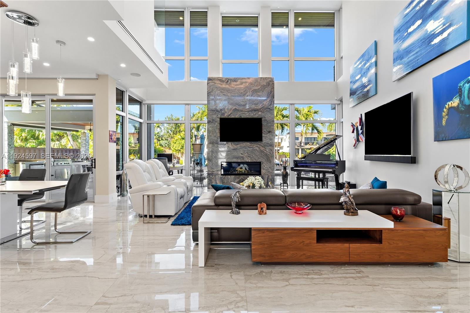 A modern waterfront masterpiece built in 2019 designed by noted architect Kevin Akey and built by Barron construction. This modern smart home features three  AC areas of flex space to accommodate one's passions such as car collections, art studio, music studio, work out space, private spacious office, teen activities areas, etc. Control 4 automation allows the owner to operate most functions of the home at the touch of a finger. A whole house generator, Sonos audio, and luxury finishes including 23 ft ceilings, custom lighting, glass walkway, floating staircase, and a chef's kitchen featuring sub zero and JennAir appliances round out the unique aspects of this home. The first floor primary suite offers spa level luxury, while the outdoor space includes a 80 ft trex multi level dock with tide slide convenience and 30 min ocean access, a large boat gear pressurized integrated storage closet, & exterior Pool / Boat guest bath,  a heated pool / spa with custom lighting, maintenance free turf yard, and an 11 car capable gated driveway.