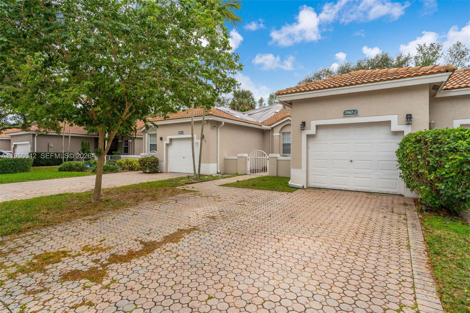 Welcome to this beautiful townhouse, perfect for a starter home. Featuring 2 spacious bedrooms and 2 full baths, this home offers a thoughtfully designed layout with high ceilings in the living area creating a bright and open feel. The remodeled kitchen is equipped with stainless steel appliances, ample cabinet space and modern finishing touches. Enjoy the convenience of an in-unit washer and dryer, tile floors throughout, plenty of closet space, and an enclosed porch for outdoor relaxation. The home also includes a detached one car garage and the added privacy of no back neighbors. Located in a gated community with a pool to enjoy. This townhouse offers comfort, privacy, and space to grow in. Schedule your appointment today!