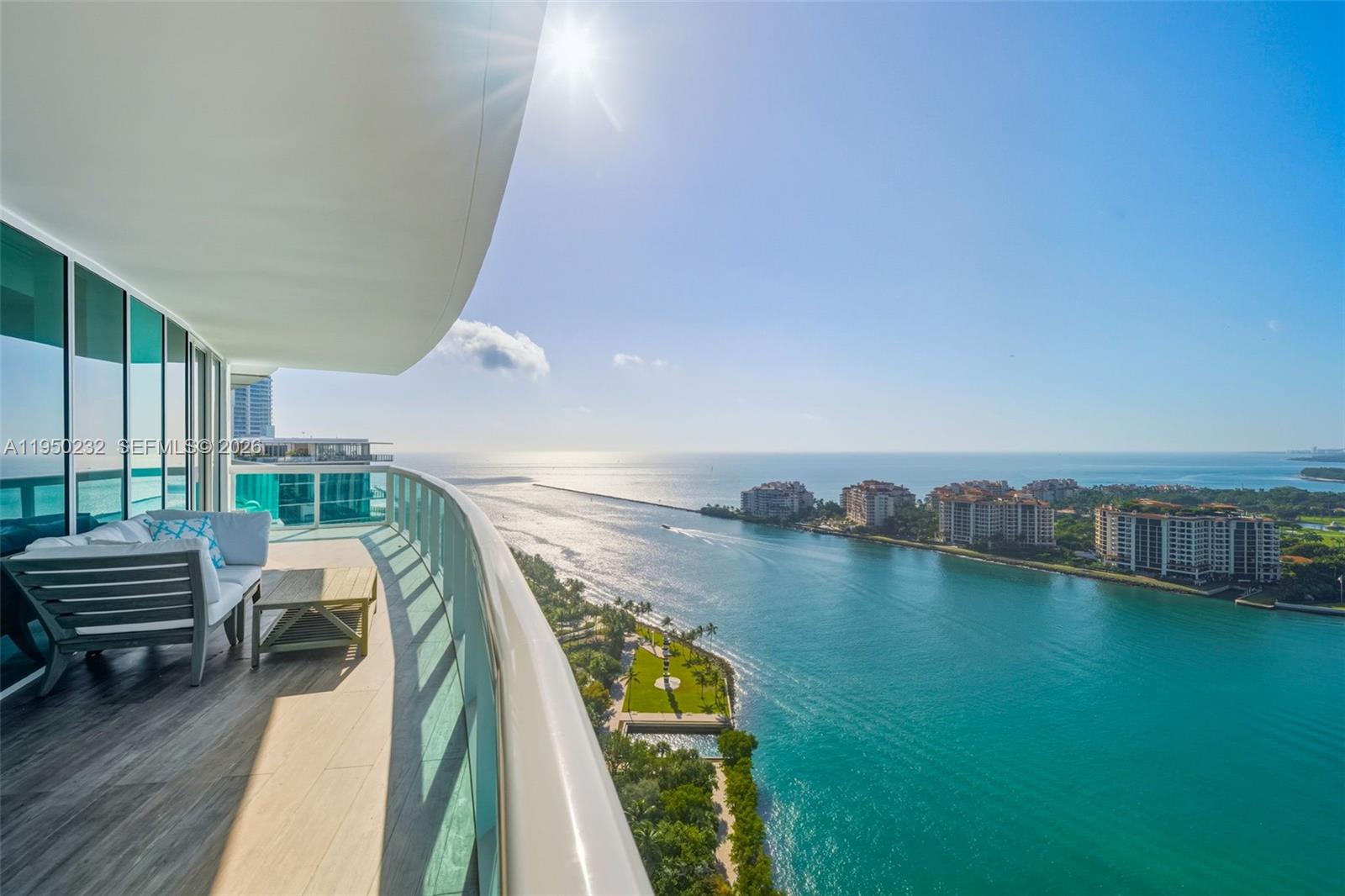 Presenting a rare high floor 02-line at Murano Portofino, ideally located in the coveted South of Fifth enclave. This flow-through home offers breathtaking ocean and bay panoramas from every room, including stunning views of Fisher Island, Downtown Miami and the Port of Miami. The elevator opens into your private foyer, unveiling a fully renovated, thoughtfully curated residence. The home features porcelain flooring throughout, custom built-in bookshelves in the living area, and beautifully remodeled bathrooms, including a spa-inspired primary bath. Additional refinements include linear vents, an integrated speaker system, automatic blackout shades, and custom lacquer-finished closets. The residence offers two expansive terraces w/ sweeping water views, ideal for seamless indoor-outdoor living. The gourmet kitchen is impeccably appointed w/ custom blue cabinetry, Sub-Zero, Wolf & Miele appliances. Renowned for its exceptional service, the building is undergoing a $60M transformation, introducing a new pool, tennis/padel/pickleball courts & cold plunge. Two-story waterfront gym/spa & a private beach club w/ pool with an on-site restaurant is now open. Enjoy exclusive BEACH SERVICE for residents w/ a private building golf cart providing transportation to & from the beach. 1 assigned parking and 1 valet and 1 storage unit. The special assessment ($171,000) has been paid by Seller.