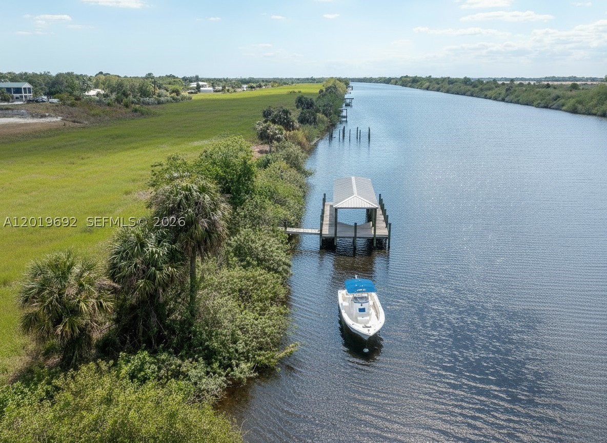 Rare Riverfront Acreage with Dock! 2.53+/- Acres, ready to build on in the Port LaBelle Ranchettes, one of the nicest communities in the area! The Intracoastal (Caloosahatchee River) offers deep water access to Lake Okeechobee, the Gulf, and the Atlantic Ocean with NO TIDES OR STORM SURGE! This is an excellent location for the waterfront home on acreage you have always dreamed of! Glades County will allow horses in this community with a special exception. There is a huge greenbelt behind the house maintained by the association. Association fee is ONLY $60 a year!