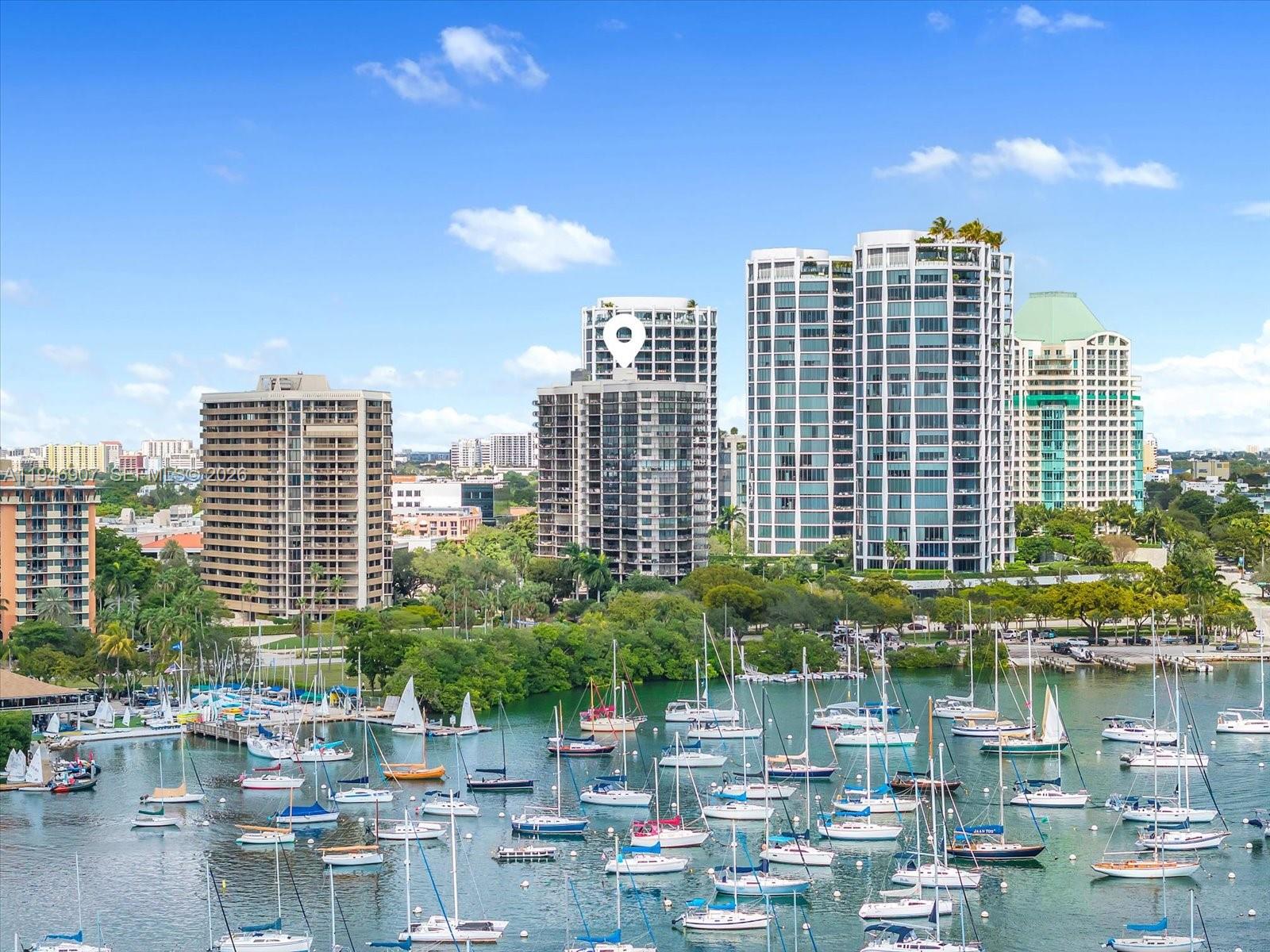 Wake up to open bay views and enjoy sunset skies over Coconut Grove from this spectacular 2-bedroom, 2-bathroom water-facing unit at Grove Towers. Overlooking Biscayne Bay, the 1,388 SF residence offers expansive water views framed by Coconut Grove’s mature tree canopy, with sailboats and greenery visible throughout the day. Features include a light-filled layout with impact windows and doors, expansive terraces, and a well-proportioned floor plan that emphasizes indoor-outdoor living. Living and bedroom spaces open directly to the balconies, allowing for consistent natural light and bay views from multiple rooms. Perfectly situated in one of the most sought-after neighborhoods of Coconut Grove, Grove Towers offers a wide variety of amenities including a heated pool and jacuzzi, tennis and pickleball courts, gym, BBQ area, storage, complimentary valet service, guest parking, EV charging stations, and one assigned garage parking space. Located just moments from the marina, sailing club, waterfront parks, cafés, boutiques, restaurants, and top-rated schools, the property offers convenient access to the best that Coconut Grove has to offer.