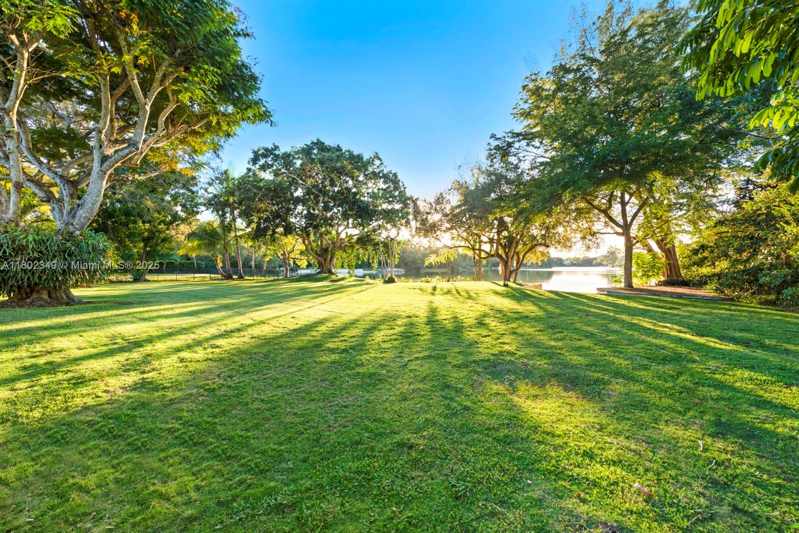 Best view lot in Hammock Lake on widest part of the lake and longest view. Seize the rare opportunity to craft your lakefront sanctuary in prestigious, gated Hammock Lakes. Nestled on a lush acre, this prime lot and residence promise breathtaking sunset vistas. Expand and enhance the existing Mid Century single-story home, distinguished by high ceilings in open, glass walled living spaces, or envision and build your own masterpiece from the ground up. Situated in one of Coral Gables’ most desirable neighborhoods, this property delivers unmatched potential to transform your dreams into reality. Experience the tranquility and remarkable appeal of this sought-after lakeside location. Rent or occupy home during design and planning process.