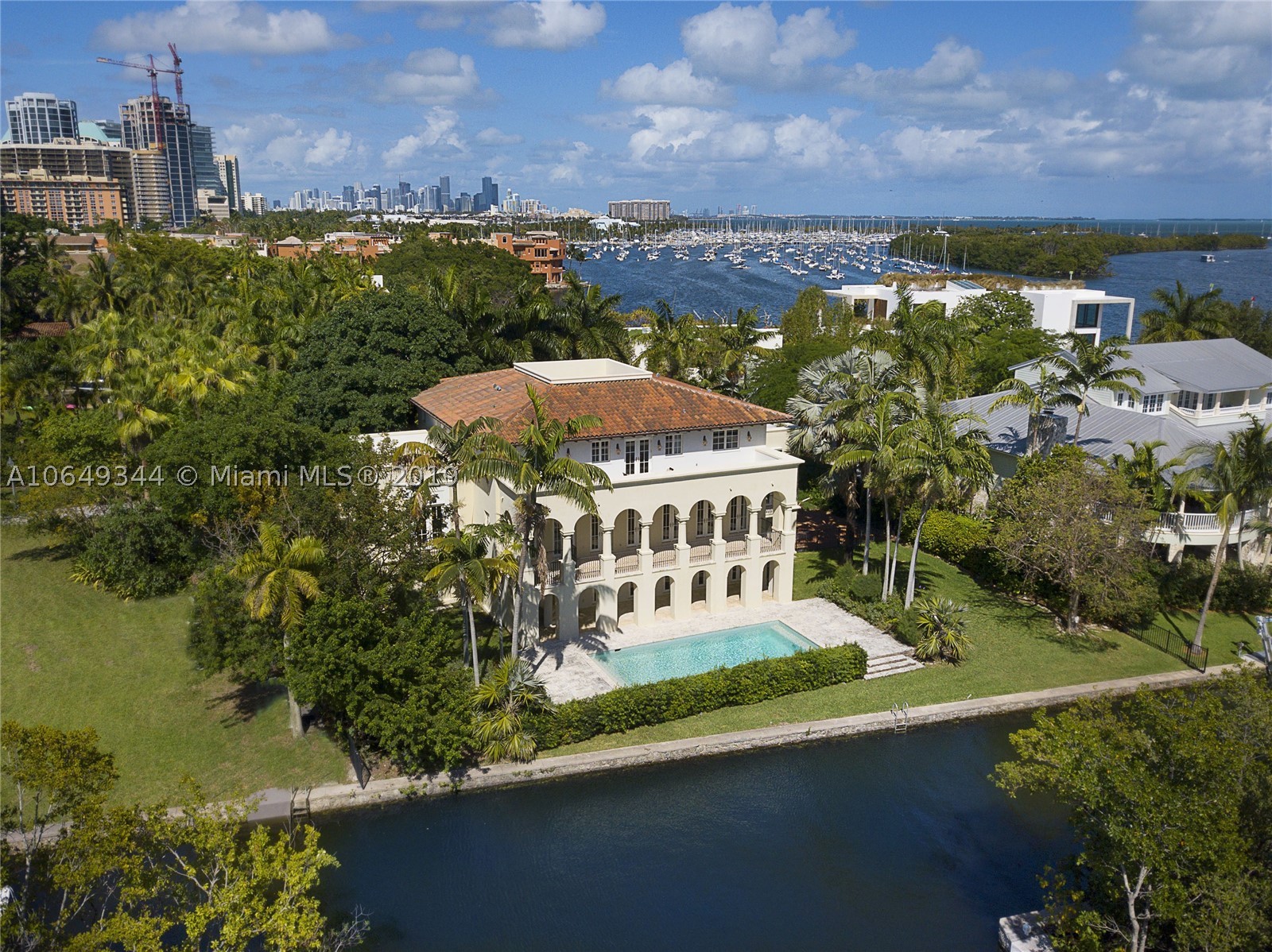 Ideally situated in the heart of the Grove behind gates of exclusive Camp Biscayne, this 2003 built home boasts 122’ of water frontage & breathtaking views of the Bay, canal & natural landscape.  The elegant style offers sophistication w/ details like mahogany trimmed impact glass drs & wndws, Brazilian wd & Jerusalem marble flrs, arches & vaulted ceilings. Formal spaces incl gracious dining rm & huge liv rm that flows out to a balcony spanning the back of the home. Cook’s kitchen offers gas, high end appliances & breakfast rm overlooking the canal. Outside are many covered balconies & open porches, including a roof top terrace & heated, saline pool w/ keystone flrs & views of the boat basin at La Brisa. 1st floor ac’d bonus space w/ full bath, 2 car gar, organic mosquito repellant system.