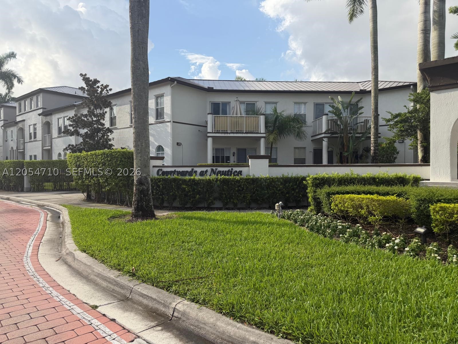 Welcome to Courtyards at Nautica, one of West Miramar's most desirable gated communities! This beautifully maintained first-floor condo offers approximately 1,340 SF with 3 bedrooms, 2 bathrooms, soaring ceilings, an open-concept layout, stainless steel appliances, modern cabinetry, elegant finishes, and two private balconies overlooking peaceful garden views. The community features recent major improvements, including a new metal roof (2025), exterior painting (2024), and parking lot resurfacing (2023). Enjoy resort-style amenities including a clubhouse, fitness center, pool, playground, scenic lake, and beautifully landscaped grounds. Includes 2 assigned parking spaces and is conveniently located near I-75, top-rated schools, shopping, dining, parks, and more. Move-in ready—an exceptional opportunity!