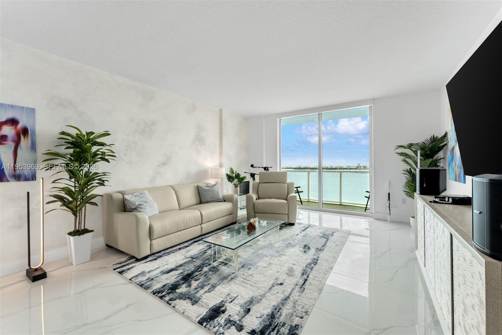 Enjoy bayfront living from the 32nd floor at Quantum on the Bay, a premier waterfront condominium ideally located just north of Downtown Miami and south of the Upper East Side. This 1,400 SF corner residence offers 2 bedrooms, 2 full bathrooms and 1 half bath, with direct bay and water views and an open, airy layout. The open-concept kitchen features a center island with sink and Bosch dishwasher, Whirlpool microwave and electric cooktop, and Samsung refrigerator. Tile flooring extends throughout the living areas and onto the open balcony, creating seamless indoor-outdoor flow. The primary suite offers double sliding doors to the balcony, a walk-in closet with built-ins, and an en-suite bath with marble vanity and tub/shower combination. The second bedroom includes a wall closet and en-suite bath with marble vanity and tub/shower. Additional features include a powder room with linen closet, water filtration system, blinds and blackout shades, laundry closet with LG washer and dryer, and central A/C. Quantum on the Bay offers full-service amenities including concierge, four elevators, two pools, spa and sauna, fitness center, business center, high-speed fiber optic internet, and secure waterfront living with spectacular views.