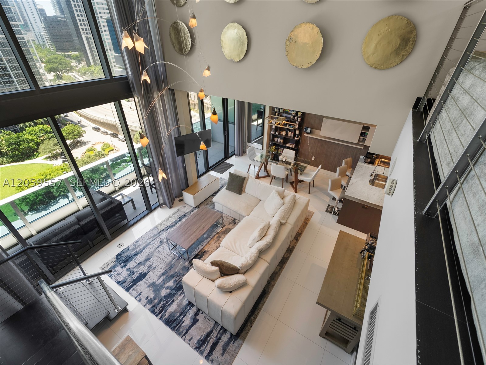 Rare two-story residence at EPIC, positioned on the highest of the building's townhome-style floors, where the Miami River meets Biscayne Bay. 

The main level offers double-height ceilings with floor-to-ceiling glass, an open kitchen, and a full-width terrace suspended directly above the river. Bay views to the east, the Brickell Avenue Bridge to the west, and yachts passing below. Upstairs, two bedroom suites each with a private balcony, joined by a loft den. Three balconies total, 2.5 baths, electric shades, one assigned parking space plus valet. 

EPIC Residences is a full-service luxury condominium with a private residential entrance, lobby, and elevators, full-time concierge, waterfront pools, spa, and fitness center, with Zuma at the riverfront level and a deep-water marina below accommodating yachts over 300 feet with bridge-free ocean access. 

A downtown address at the foot of the Brickell Bridge. Walk to Brickell, Whole Foods, Silverspot Cinema, and Bayfront Park, beside the Aston Martin Residences on the final stretch of the Miami Riverwalk. Two full stories, three balconies, five-star services - a combination that rarely reaches the Miami market.