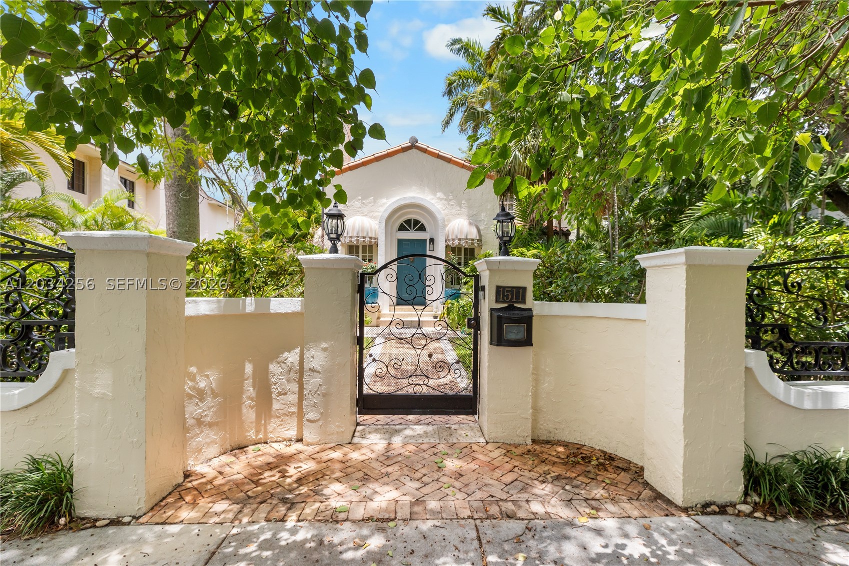 Timeless Spanish Mediterranean estate nestled on an oversized 8,625 SF lot in the heart of Shenandoah. Surrounded by mature tropical landscaping and located on one of the neighborhood's most picturesque tree-lined streets, this 4-bedroom, 3-bath residence offers a rare combination of architectural character, privacy, and location. A gated brick motor court and exceptional curb appeal create an unforgettable first impression. Inside, soaring vaulted ceilings with exposed beams, abundant natural light, rich hardwood floors, elegant archways, and a grand fireplace showcase the home's timeless charm. The spacious layout is ideal for both comfortable living and entertaining. Step outside to your private tropical oasis featuring a sparkling pool, lush gardens, and multiple outdoor gathering spaces. Adding to the property's appeal is a detached 1-bedroom, 1-bath guest house, perfect for extended family, guests, a home office, or additional flexibility. Ideally located just minutes from Brickell, Coral Gables, Coconut Grove, Downtown Miami, top-rated dining, shopping, and entertainment. A rare opportunity to own one of Shenandoah's most distinctive and desirable properties.