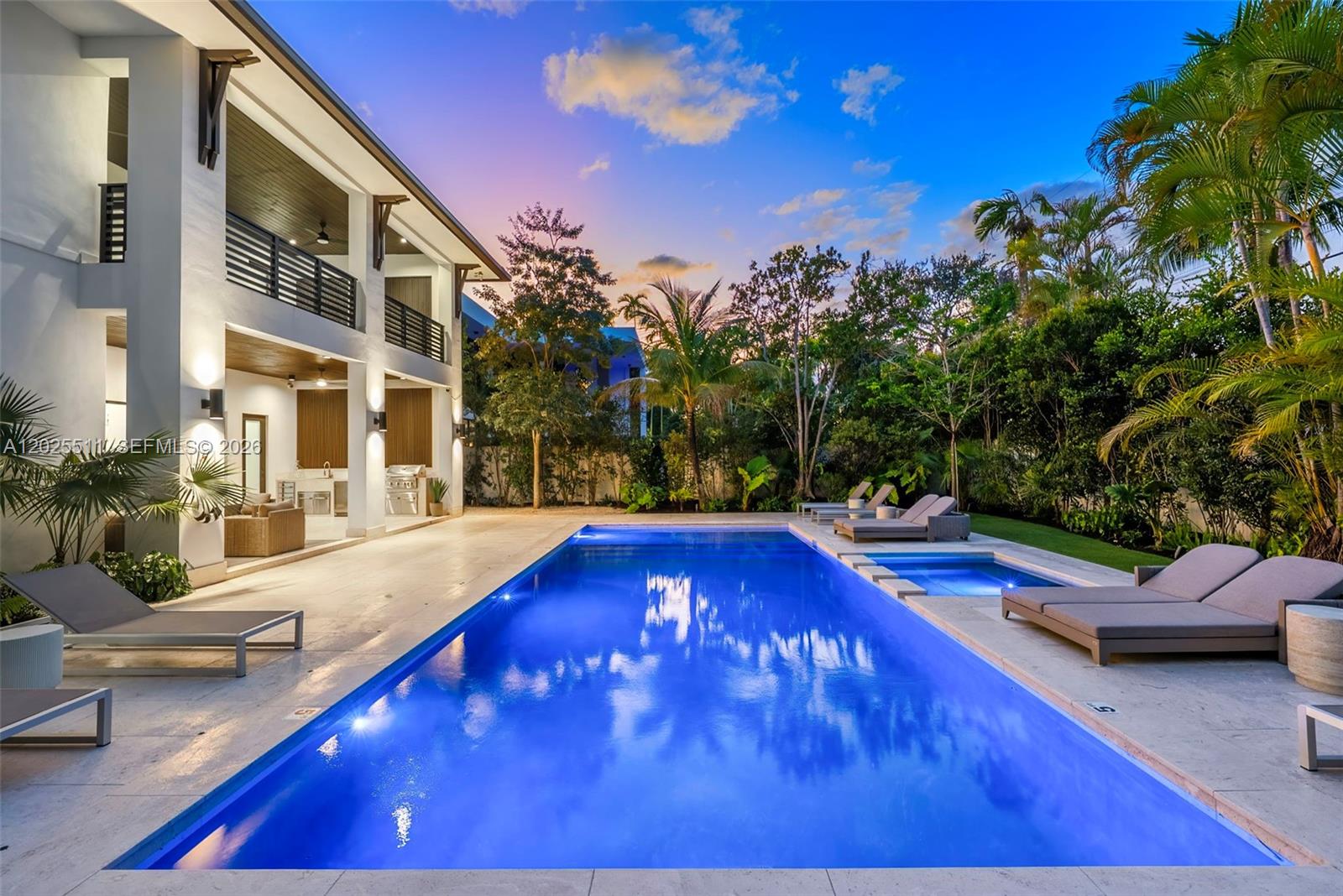 A Masterwork of Miami Modern Living
The latest creation by award-winning architect Hamed Rodriguez, where Miami modernism meets Caribbean soul. Nestled on lush tropical grounds canopied by majestic mature trees, this extraordinary villa offers 5 en-suite bedrooms and 6 baths with an effortless sense of arrival from the moment you step inside.

Walls of glass dissolve the boundary between indoors and out, drawing the eye toward covered terraces perfect for alfresco lounging and dining. Warm wood plank floors and cool limestone tiles flow throughout, while soaring ceilings and abundant natural light give every space an open, airy quality that is grand yet deeply livable.

At the heart of the home, a chef's kitchen of exceptional caliber features custom cabinetry, a dramatic 12-foot quartz island with waterfall finish, and a full suite of high-end appliances including built-in oven/microwave combo, professional cooktop, wall hood, dishwasher, and wine cooler — ideal for hosting private chef dinners.

Outside, coral stone floors and accent walls evoke quintessential Miami elegance. A fully equipped summer kitchen and resort-style pool with spa — straight from the pages of a design magazine — invite endless hours under the South Florida sun.