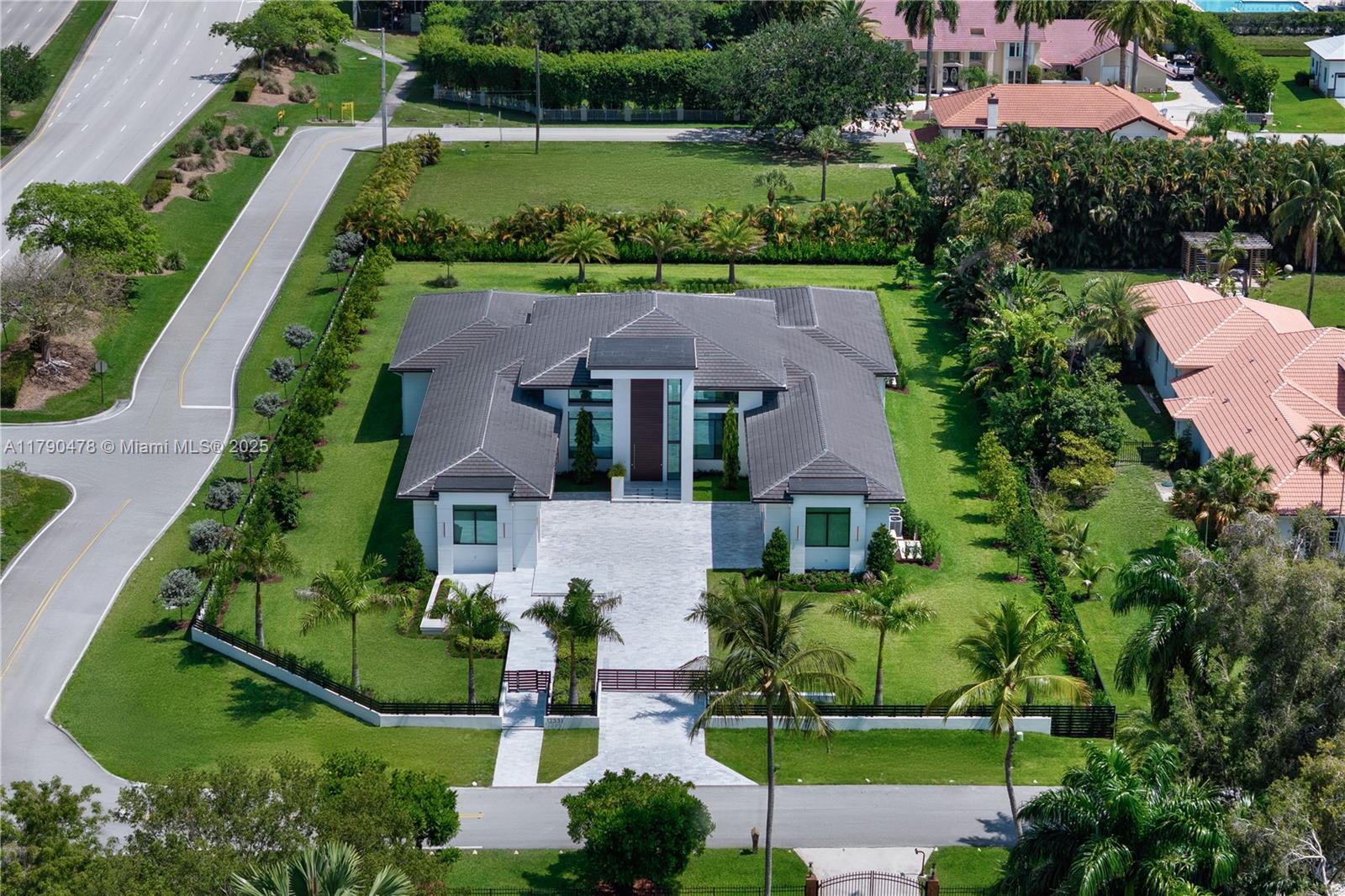Modern residence in Plantation, FL: contemporary luxury on a private 1.1-acre lot. 5,599 sq ft climate-controlled. A 27-ft porch, 10-ft door, high ceilings, marble floors. 4 bedrooms, including primary suite with spacious closets and expansive shower. Italian-designed kitchen with 7x11 island and THERMADOR appliances. Includes a fully equipped movie theatre, sound system SONOS interior & exterior, spacious office, 3-car garage, 2 covered parking and driveway for up to 6 additional cars. Outside, 48x17 pool with jacuzzi, LED lighting, waterfalls, Viking summer kitchen, and 1,000 sq ft terrace. Tech-ready smart systems and surveillance cameras. High-end design and amenities. Close to AHS school, Supermarket, gas station, Major intersections and highway.