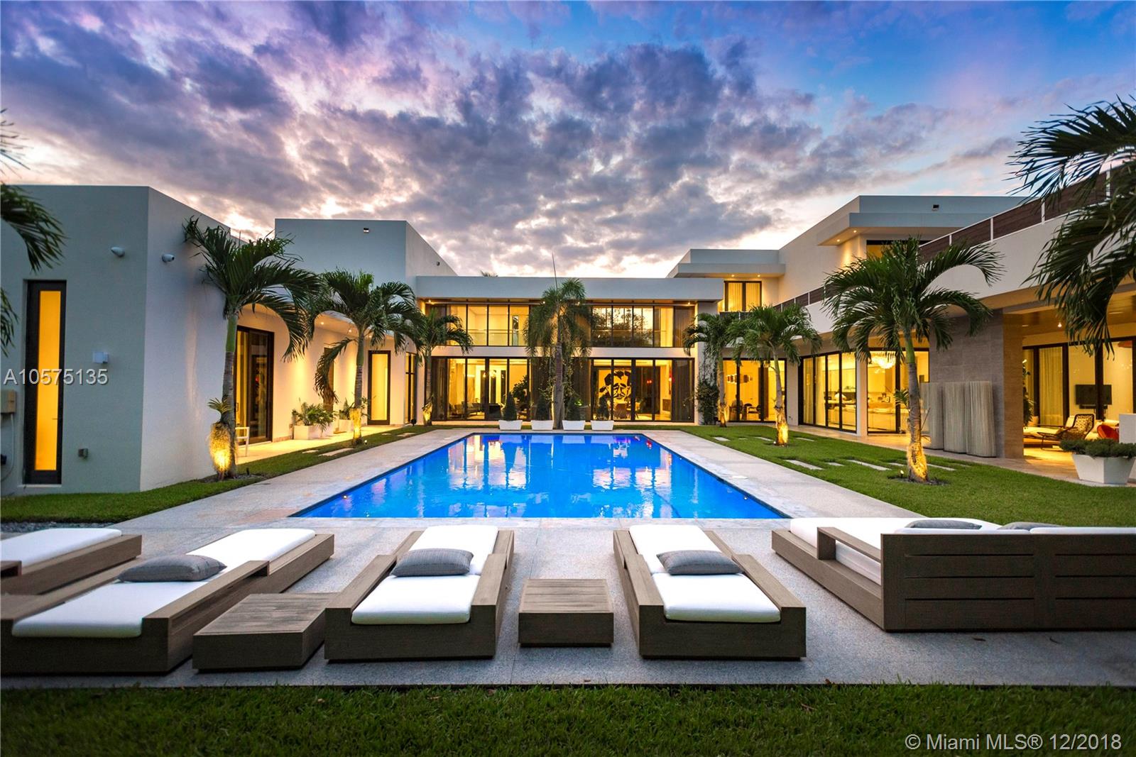 Designed with the art collector in mind, this unique two-story modern estate spans a generous 9,855 sqft and includes 9 Bedrooms and 9.5 Bathrooms. Laid out to easily communicate with the spacious Guest house/In-law suite, summer kitchen and outdoor entertainment area. Ideal for a family or a multi-generational family. Master suite boasts over-sized his/her closets and private sundeck. Outfitted with state-of-the-art smart-home technology with 20 security cameras, 24-foot ceilings, floor-to-ceiling impact windows, stainless steel state-of-the-art Wolf and Sub-Zero appliances, marble/wood flooring throughout, 7 seat home theater, 432 bottle wine cooler, private elevator, 150KW generator and a heated infinity edge pool sitting on an impeccably landscaped 37,897 sqft lot.