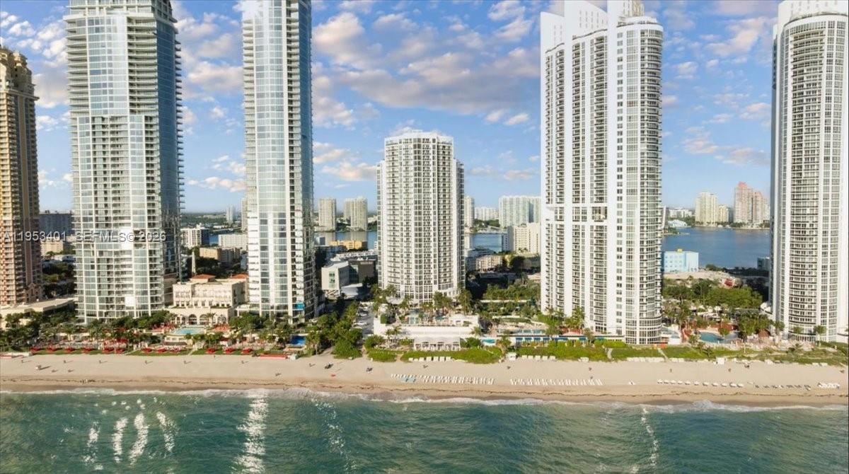 18001 Collins Ave Unit #1111 located at the prestigious Trump International Sonesta Hotel offers refined oceanfront living in the heart of Sunny Isles Beach. This spacious residence sits high above the shoreline, delivering breathtaking panoramic views of the Atlantic Ocean and coastline through expansive floor-to-ceiling windows that flood the home with natural light. The open-concept layout is designed for both comfort and entertaining, featuring a generous living and dining area that flows seamlessly to a private balcony—perfect for sunrise coffee or evening relaxation with the sound of the waves. The kitchen is thoughtfully appointed with ample cabinetry, quality finishes, and plenty of counter space, ideal for everyday living or hosting guests. The primary suite provides a tranquil retreat with stunning water views, a well-proportioned closet, and a spa-inspired bathroom. Every detail of the residence is designed to maximize space, light, and functionality while maintaining an elegant coastal feel. Located directly on Collins Avenue, this oceanfront building places you just minutes from world-class dining, luxury shopping, parks, and entertainment. Residents enjoy the convenience of beachside living combined with easy access to Aventura, Bal Harbour, and Miami. Unit #1111 is an exceptional opportunity to experience the best of South Florida’s resort-style lifestyle in one of Sunny Isles Beach’s most desirable locations.