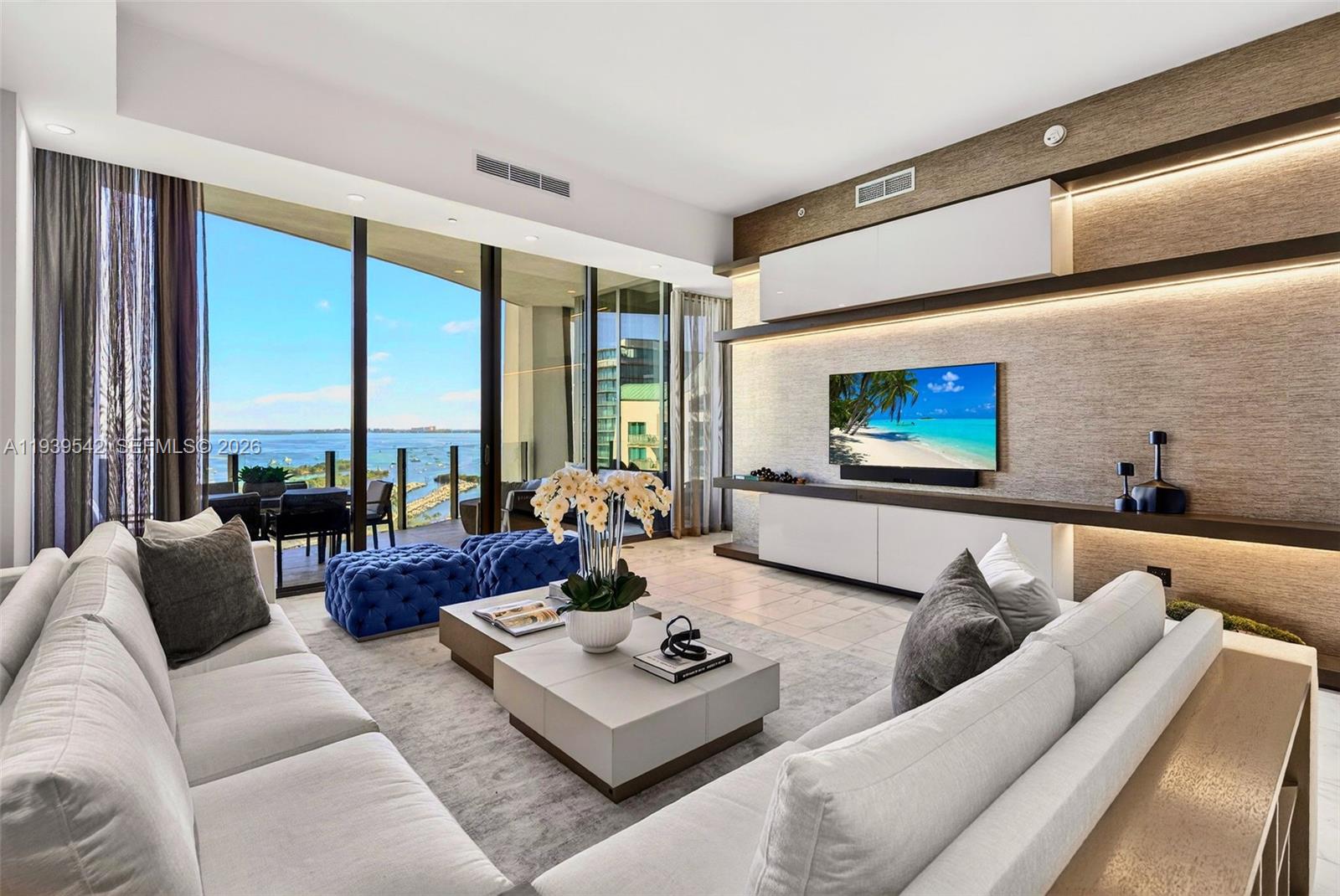 A refined Adriana Hoyos designed residence in coveted Two Park Grove, this 4-bed, 3.5-bath + den spans 2,532 SF and showcases over $1M in upgrades. Elegant marble floors flow throughout, complementing custom built-ins and abundant storage. The sleek Italkraft kitchen features a Sub-Zero fridge/freezer, 5-burner Wolf gas range, Wolf steam oven, microwave, and wine fridge. 4th bedroom is currently a den/office/family room and three other bedrooms offer en suite bathrooms. Floor-to-ceiling windows frame bay and pool views, enhancing the home’s seamless indoor/outdoor flow. Residents enjoy resort-style amenities including valet, full-service spa, fitness center, yoga/Pilates studio, theater, multiple pools, and a private restaurant. Located in one of Miami’s most desirable neighborhoods, this turnkey residence offers sophisticated living steps from parks, marinas, and the best of Coconut Grove. Includes 2 assigned parking spaces and storage.