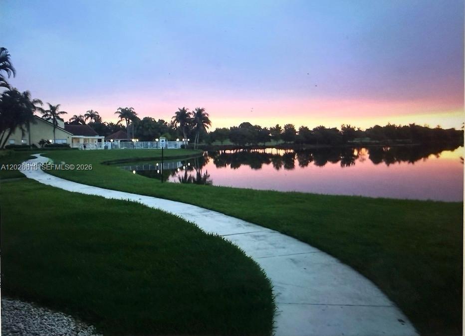 Beautiful 1-bedroom, 1-bathroom unit with a den, located on the first floor and offering stunning lake and golf course views. Features tile flooring throughout, a spacious bathroom with double sinks and a walk-in shower, a cozy breakfast area, hurricane shutters, and windows with a clear protective interior film. Washer and dryer are conveniently located inside the unit. Enjoy resort-style living with exceptional community amenities, including two resort-style pools, a fitness center, two tennis courts, two racquetball courts, and BBQ areas. Ideally located near Sawgrass Mills Mall, shopping, dining, and major highways. EASY TO SHOW! :)