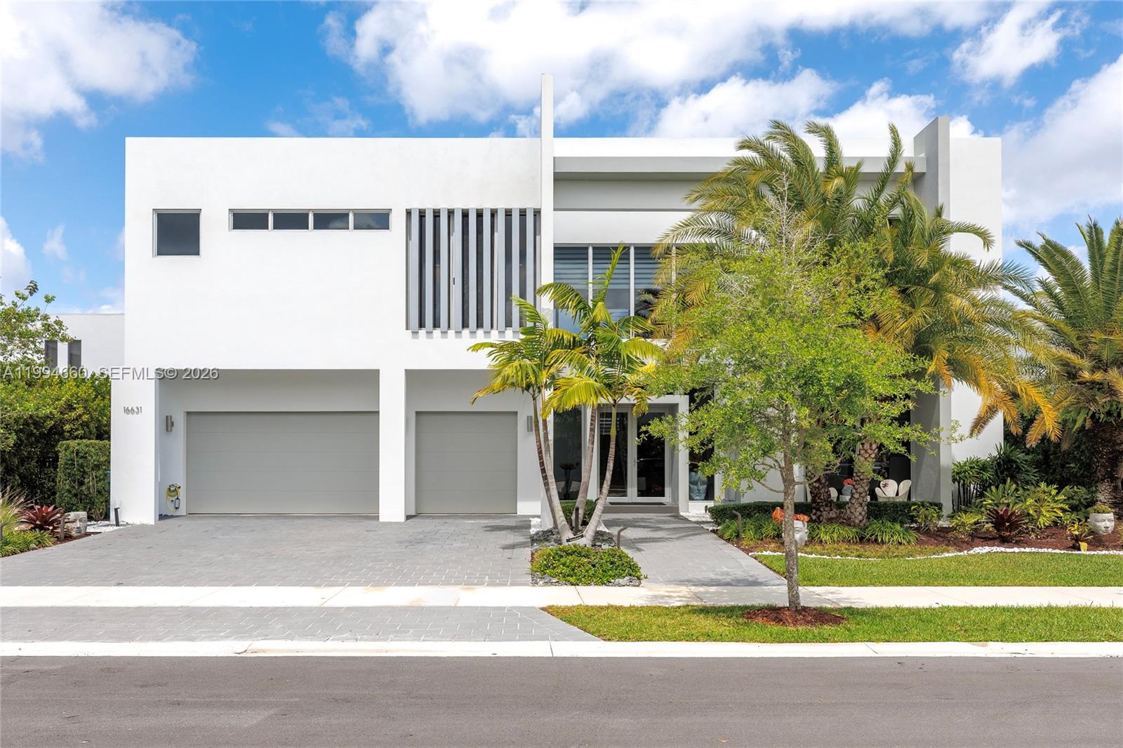 Spectacular modern lakefront estate in prestigious Botaniko Weston. Built in 2019 and designed by world-renowned architect Mateu, this stunning two-story residence offers 5 bedrooms, 5.5 baths and a 3-car garage. The true highlight is the extraordinary backyard created for entertaining and recreation. Enjoy a private oversized pool, summer kitchen, expansive lounge areas & multiple pergolas, including one with a retractable roof. The grounds feature a rare collection of amenities including a pickleball court, bocce court and life-size outdoor chess area, creating a one-of-a-kind lifestyle experience. With its architecture, setting and exceptional outdoor living, this residence represents a remarkable opportunity and one of the most compelling values currently available in Botaniko Weston.