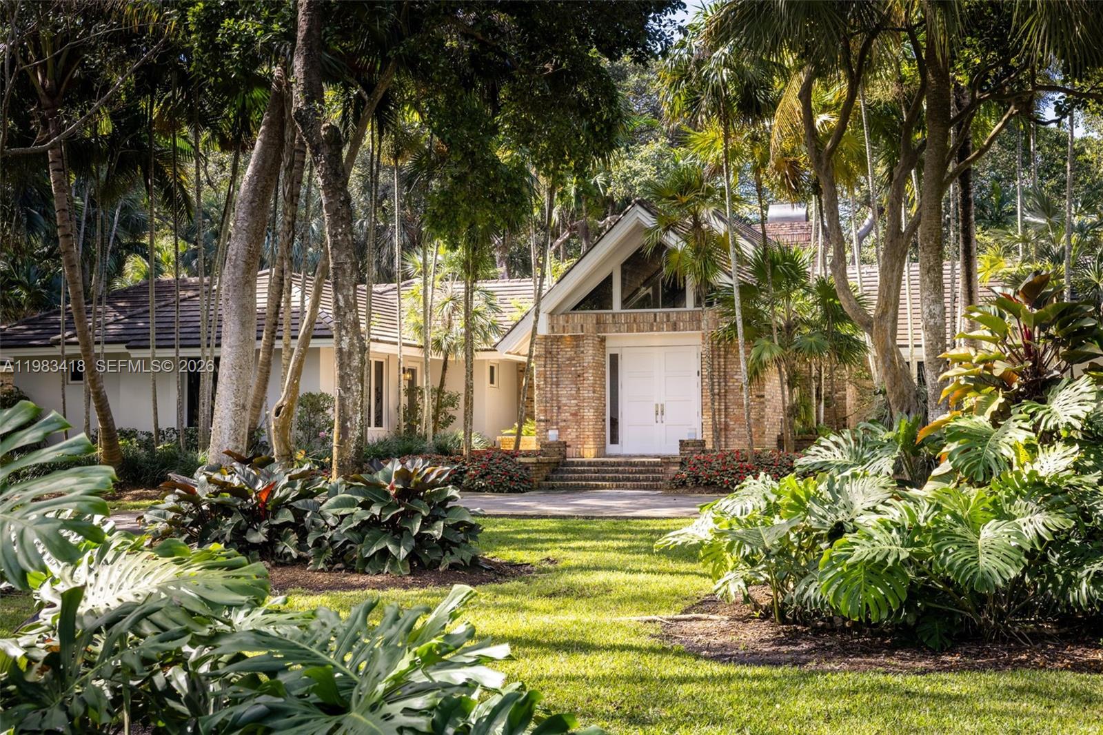 Tucked inside Gables Estates, 9000 Arvida Drive is a truly rare offering. Set on 2.5 acres in the prestigious guard-gated community, this property delivers unmatched privacy and natural beauty. The single-story estate features a timeless layout centered around spacious living areas and plenty of room for entertaining. The home is surrounded by lush gardens and a spectacular native Florida hammock with over 200 mature trees. Adding to the property's uniqueness, a portion of the land is protected as part of the local natural forest, offering special tax considerations. This also provides the utmost privacy from the famed Old Cutler Road, which can be accessed via the backyard. Opportunities like this are few and far between in Gables Estates.