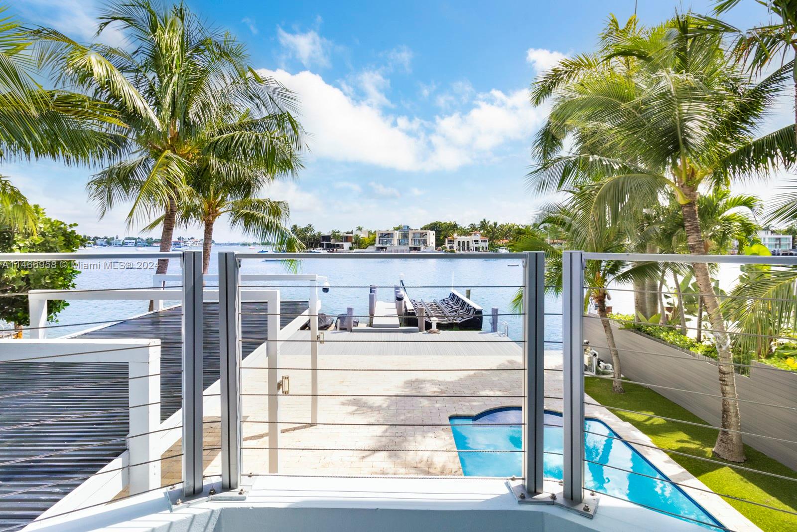 This spectacular waterfront home has been totally renovated with a construction upgrade of a new entrance and third floor railings in 2019. All the bedrooms are in suites and facing the open bay. 5 bed 5 1/2 bath with rooftop terraces. 36 x 24 CARIBBEAN BLUE marble & wood floors throughout. Beautiful kitchen with top of the line appliances, granite counter tops, impact windows, storage room, sound system, brand new back-up generator installed in 2023, new dock and a 50 linear foot seawall. New floating lift that holds up to 25, 000 lbs, and a floating dock for 2 jet ski. The Second and third floor of the house were built in 1989. With breathtaking views this beautiful property is ready for a new owner. Come enjoy the gorgeous view of the bay, and Miami.