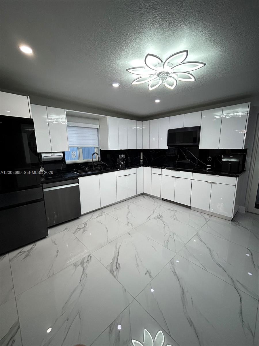 7 bedrooms & 3 baths in the heart of Hialeah! This beautifully updated home has porcelain floors, black/steel appliances, Granite kitchen counters and center island in its large kitchen, storm windows, gazabo, fully equipped  summer kitchen, a large storage shed and many more great features. Currently used as a 3/2 main house and two 1/1 units now rented for $2000. This is the perfect home for a large family or possibly as an income producing ALF. Twenty minutes from MIA, this house is close to restaurants, shopping, medical services and places of worship.