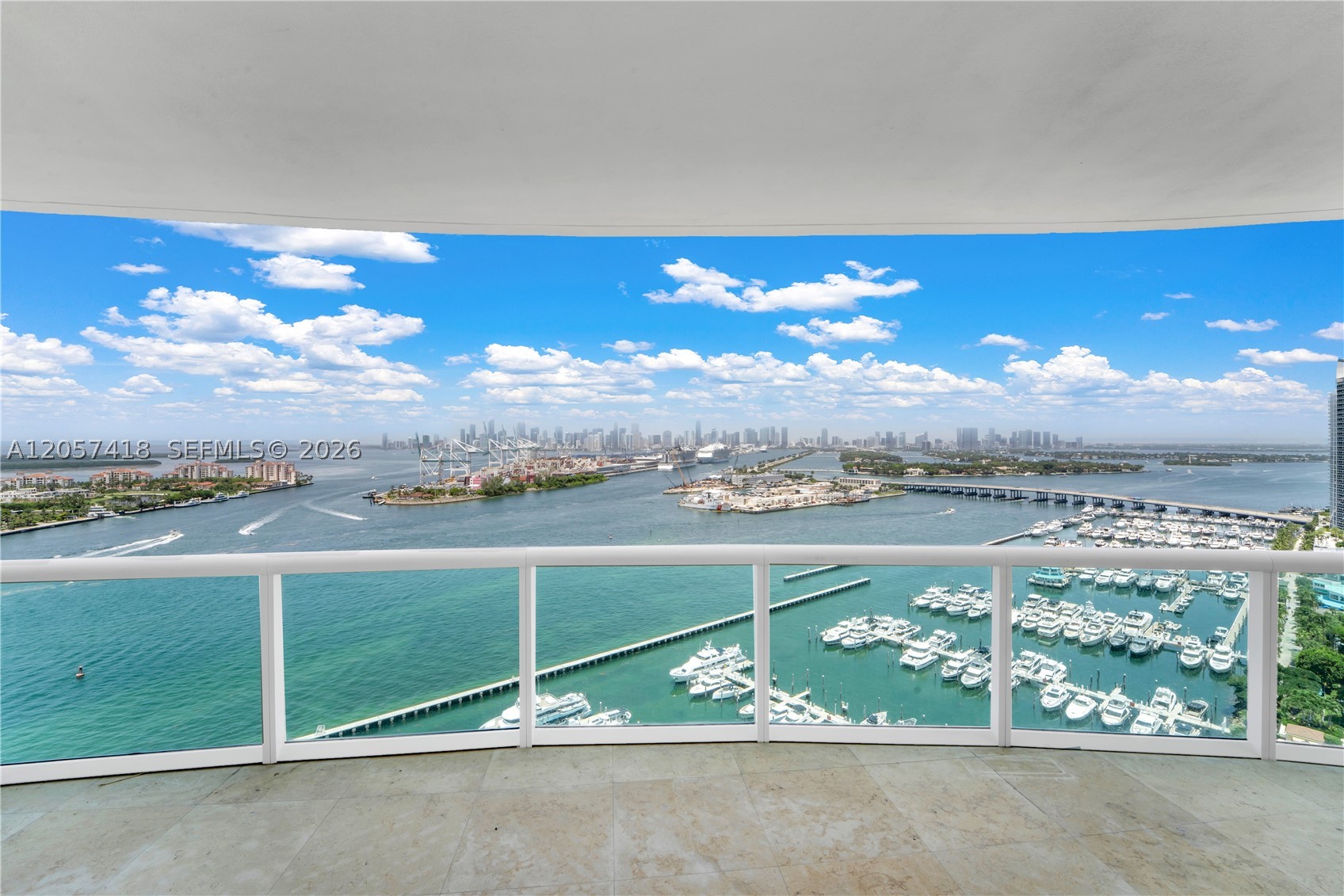 Experience elevated Miami Beach living in this rare 01-line residence. This expansive 3-bedroom, 3.5-bath condominium spans 3,365 square feet and showcases breathtaking 360-degree views, seamlessly blending sophistication with timeless elegance. Designed for comfort and style, the light-filled interior features floor-to-ceiling windows framing spectacular ocean, city, and skyline vistas. Rich marble flooring and hand painted ceilings enhance the open-concept design, creating a bright, refined living space. The gourmet chef's kitchen features premium natural stone countertops, top-of-the-line appliances, and flows effortlessly into the dining and living areas—ideal for entertaining and everyday living. The luxurious primary suite offers a spa-inspired bathroom with a soaking tub, glass-enclosed shower, and custom walk-in closet. Expansive private terraces provide the perfect setting to enjoy both sunrise over the Atlantic and spectacular sunset views across the Miami skyline. Residents enjoy resort-style amenities including a private beach club, pool, full-service spa, state-of-the-art fitness center, restaurant, tennis courts, private elevator access, and concierge services. Additional conveniences include assigned parking, valet, doorman, and guest parking. Offering an exceptional blend of luxury, comfort, and world-class amenities, this residence presents a rare opportunity to own one of Miami Beach's most coveted waterfront homes.