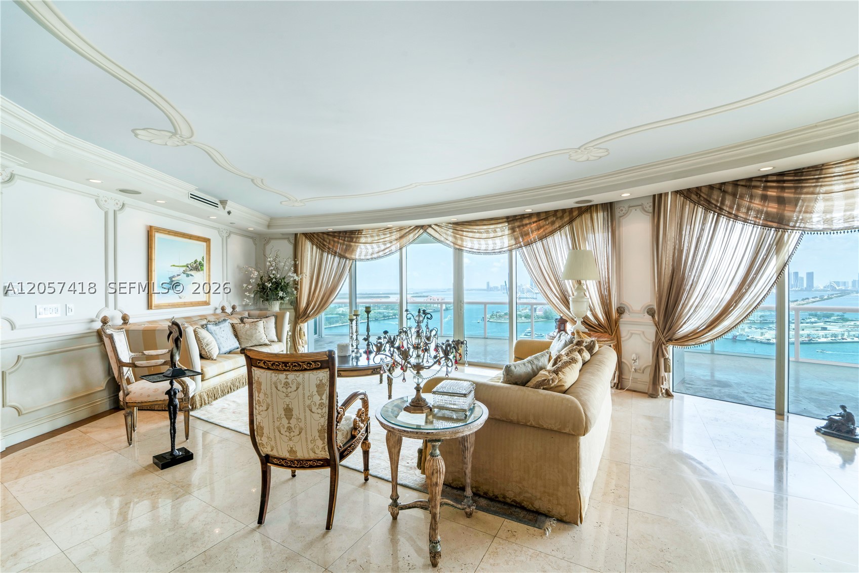 Experience elevated Miami Beach living in this rare 01-line residence. This expansive 3-bedroom, 3.5-bath condominium spans 3,365 square feet and showcases breathtaking 360-degree views, seamlessly blending sophistication with timeless elegance. Designed for comfort and style, the light-filled interior features floor-to-ceiling windows framing spectacular ocean, city, and skyline vistas. Rich marble flooring and hand painted ceilings enhance the open-concept design, creating a bright, refined living space. The gourmet chef's kitchen features premium natural stone countertops, top-of-the-line appliances, and flows effortlessly into the dining and living areas—ideal for entertaining and everyday living. The luxurious primary suite offers a spa-inspired bathroom with a soaking tub, glass-enclosed shower, and custom walk-in closet. Expansive private terraces provide the perfect setting to enjoy both sunrise over the Atlantic and spectacular sunset views across the Miami skyline. Residents enjoy resort-style amenities including a private beach club, pool, full-service spa, state-of-the-art fitness center, restaurant, tennis courts, private elevator access, and concierge services. Additional conveniences include assigned parking, valet, doorman, and guest parking. Offering an exceptional blend of luxury, comfort, and world-class amenities, this residence presents a rare opportunity to own one of Miami Beach's most coveted waterfront homes.