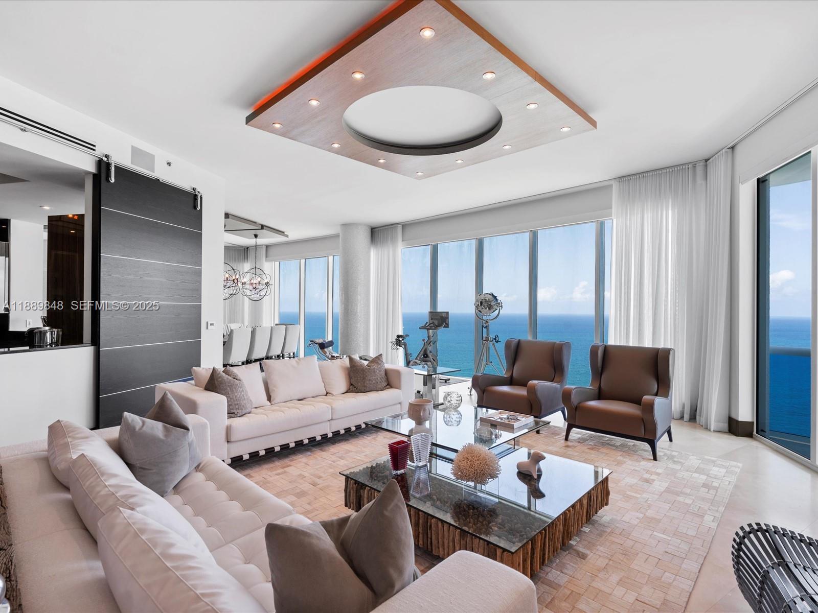 Soaring 12-foot ceilings and 5,086 SF of interior space set the tone in this ultra-exclusive Sky Residence—commanding the entire 40th floor of the iconic Trump Hollywood. A private elevator opens into a Robert M. Swedroe-designed sanctuary where walls of glass capture endless ocean, Intracoastal, and sunset views, amplified by nearly 1,000 SF of terraces.

Inside: Crema Marfil marble floors, bespoke millwork, and a $500K+ Crestron system delivering true five-star control and comfort. For the collector-connoisseur: 10 parking spaces (with 9 contiguous), 10 storage units, 3 wine lockers, and a private cigar lounge humidor—a rare level of ownership utility.

White-glove living rounds it out with 24/7 concierge, valet, attended beach service, spa, pool, fitness center, and a private restaurant—an estate in the sky built for those who don’t compromise.