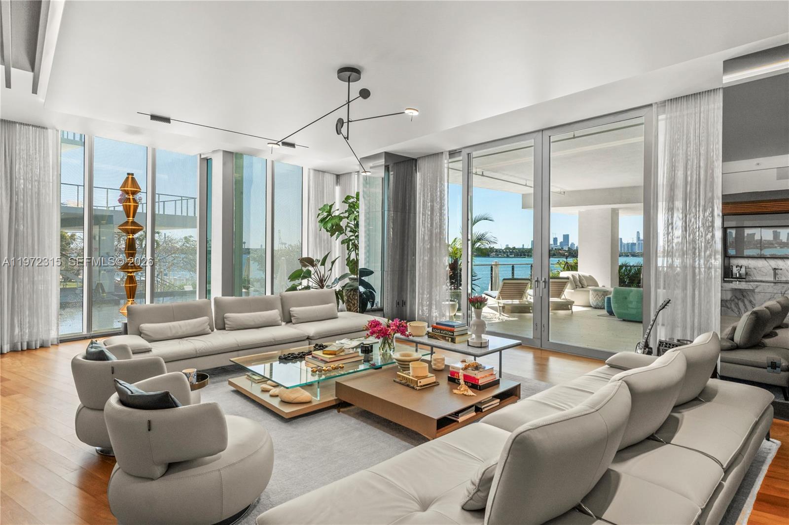 This 3Be/3.5Ba condo offers 3,107 SF of interior & an expansive 800 SF terrace. The bright open layout and striking architecture creates seamless indoor-outdoor flow while lush vegetation ensures total privacy. The chef’s kitchen features a sculptural Calacatta marble island, custom cabinetry & premium built-ins. The oversized primary includes a large walk-in closet, a spa-style bath w/ veined stone, marquetry flooring, Italkraft custom closets & tiled walls. All additional bedrooms are ensuite. Teak flooring, designer fixtures, 10’5” Ceilings, recessed lighting, AV-Savant system, marble statement walls,custom wallpaper, a bespoke bar, and private elevator access complete the home. Set in an exclusive boutique condo by Pritzker Price winning architect Jean Nouvel, near Sunset Harbour and West Avenue, it offers privacy and prime Miami Beach access.